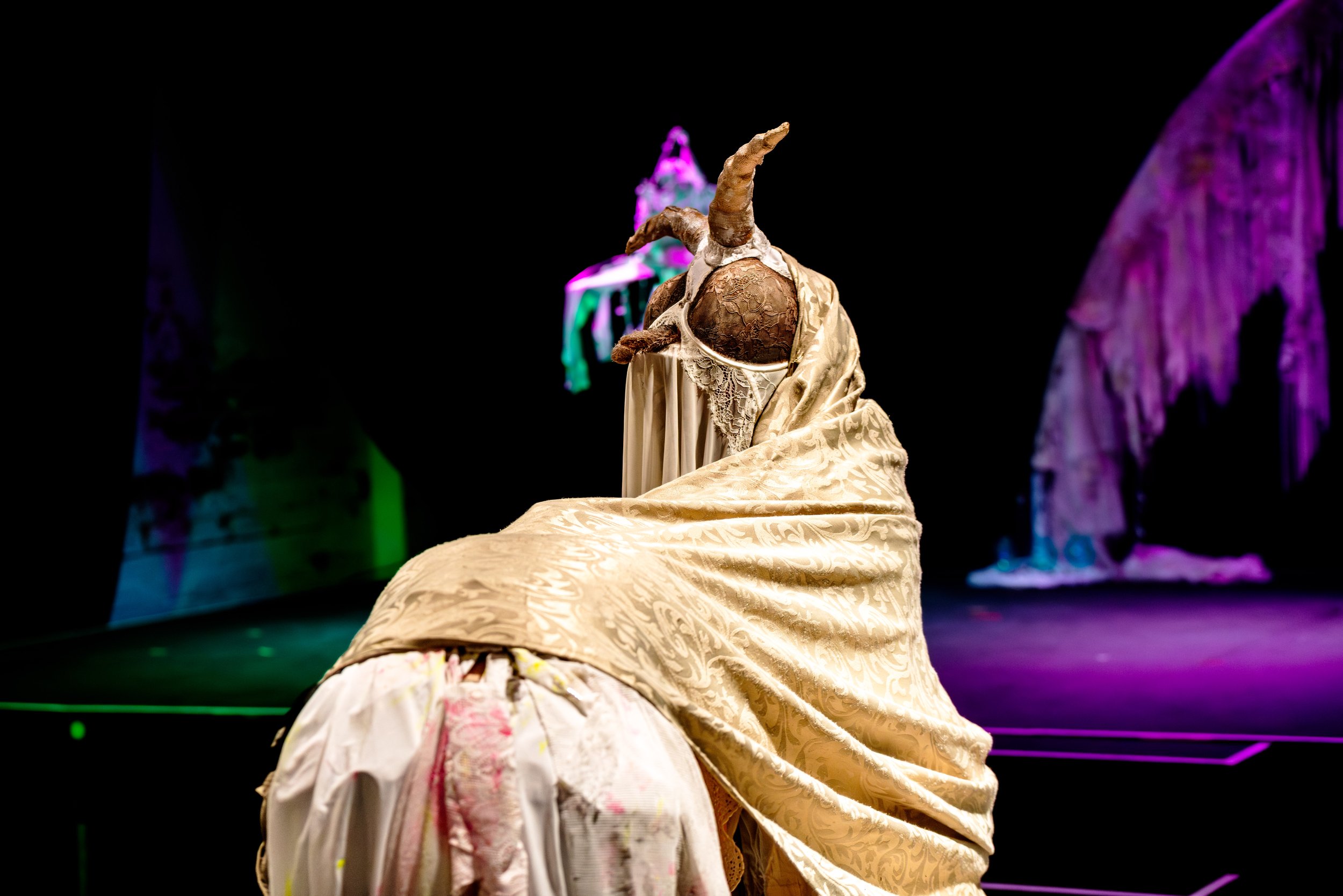 A weird creature trundles towards the stage.