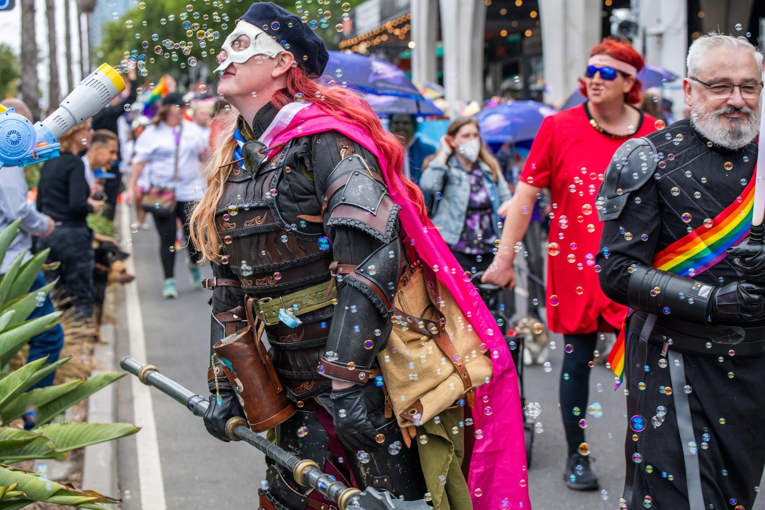 A human in cosplay leans into bubbles.