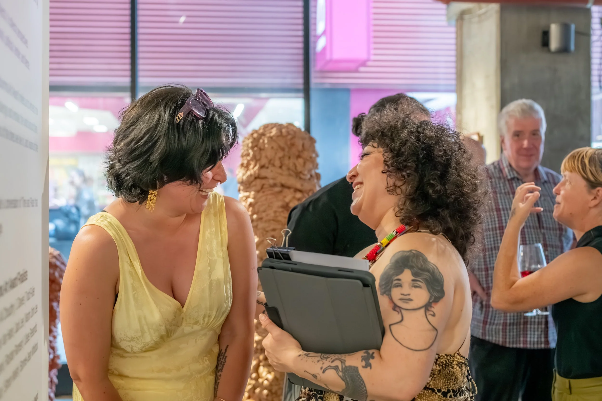 Two humans laughing with each other.