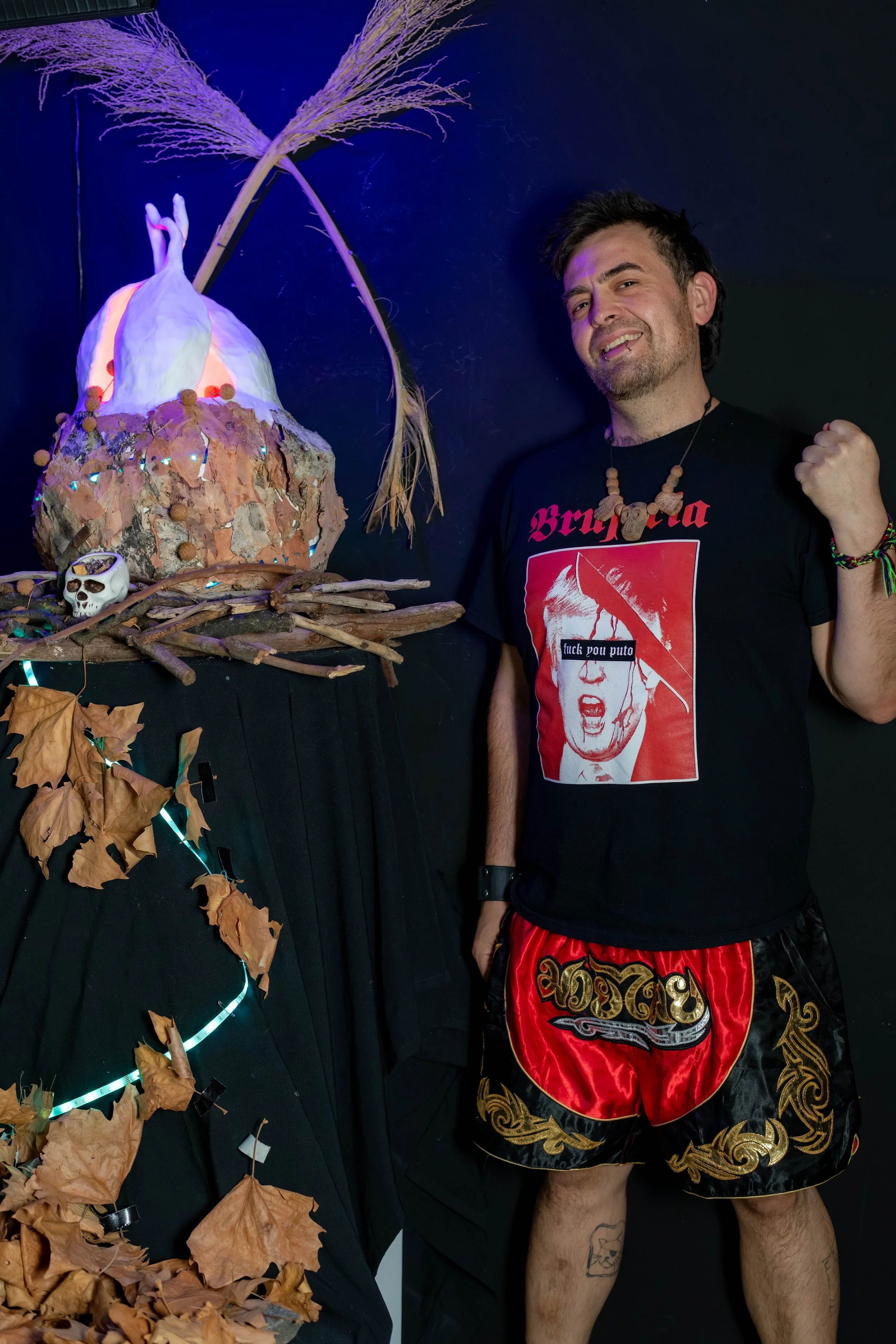 Vernon Rodrigues next to their neon lit sculpture.