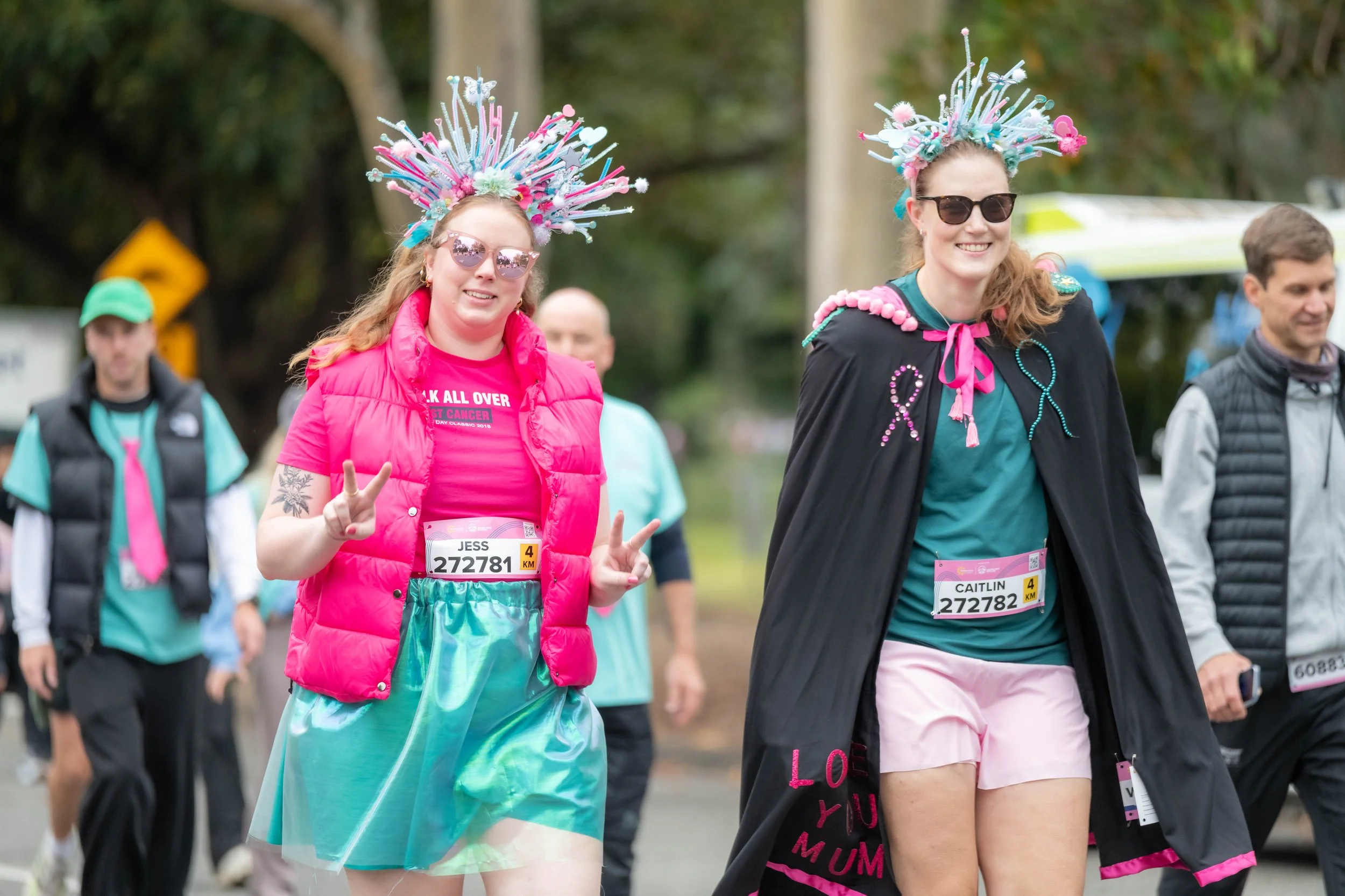 Two humans wearing pipe cleaner headdresses.