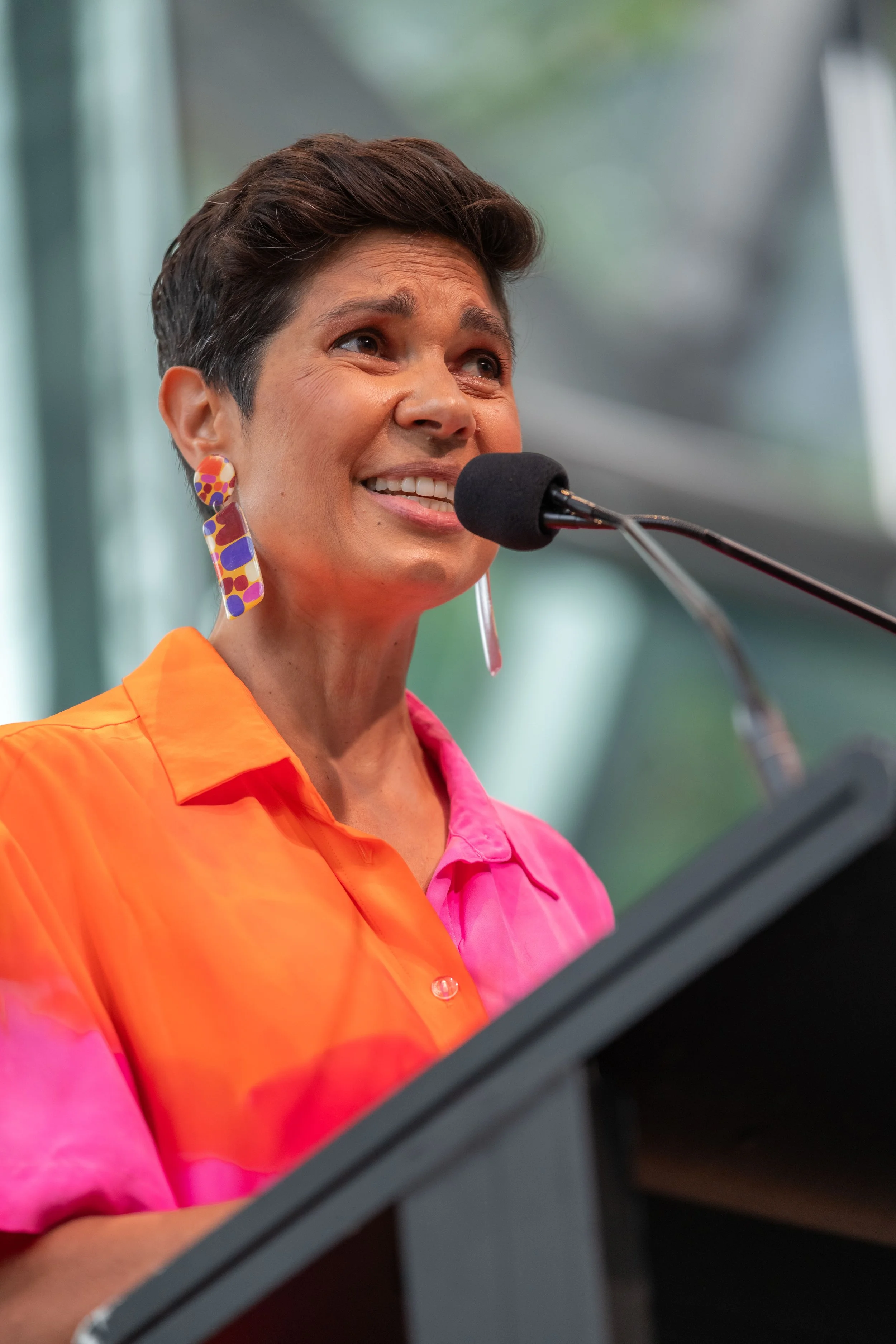 Narelda Jacobs speaks into a microphone.