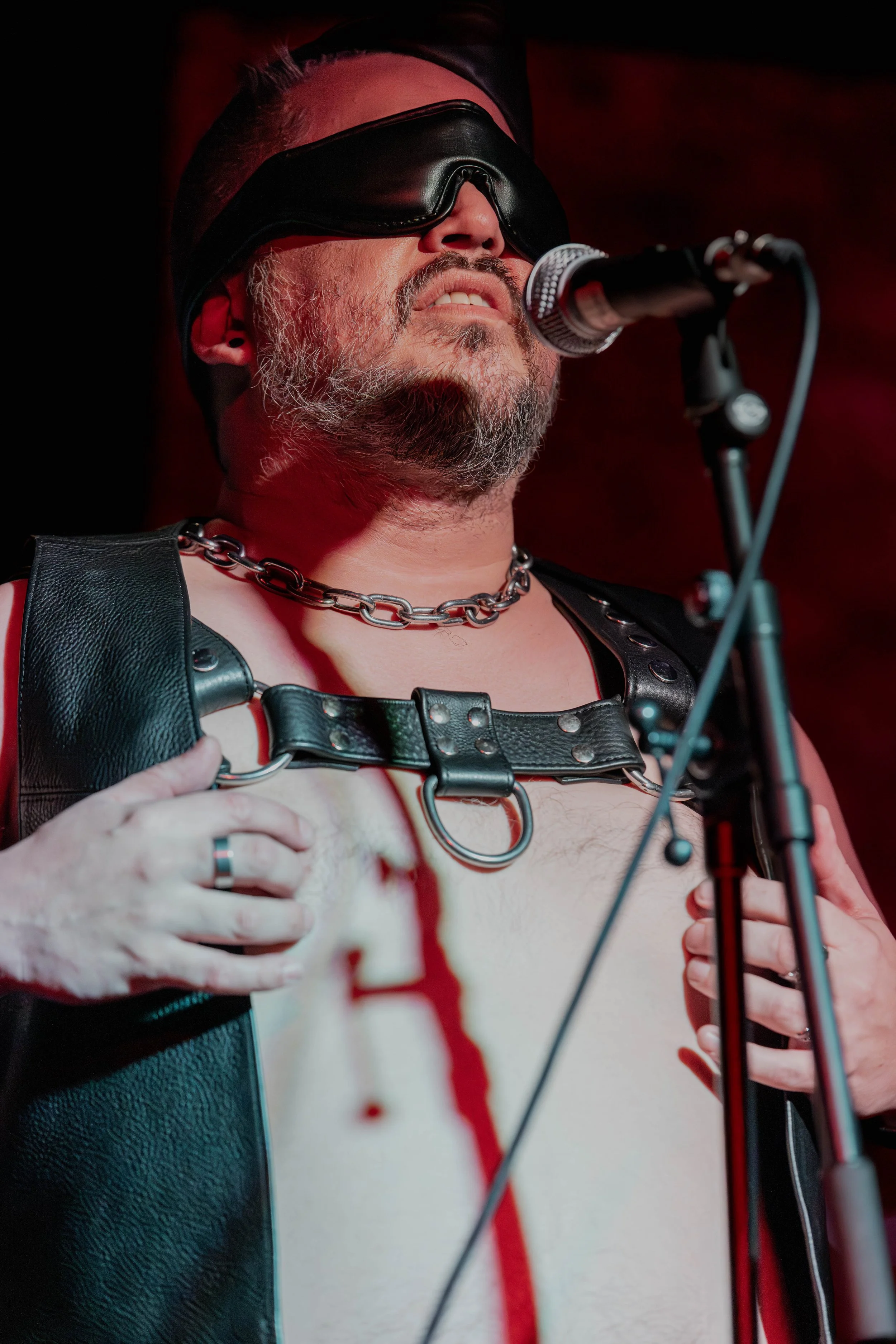 Whilst blindfolded, Andrew Rose holds onto his leather vest.