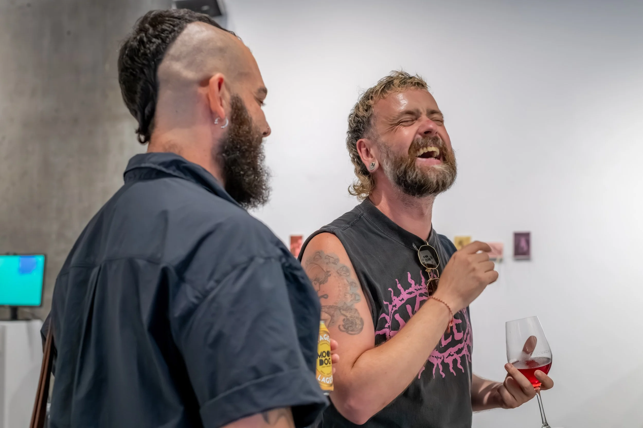 Two humans laughing heartily.