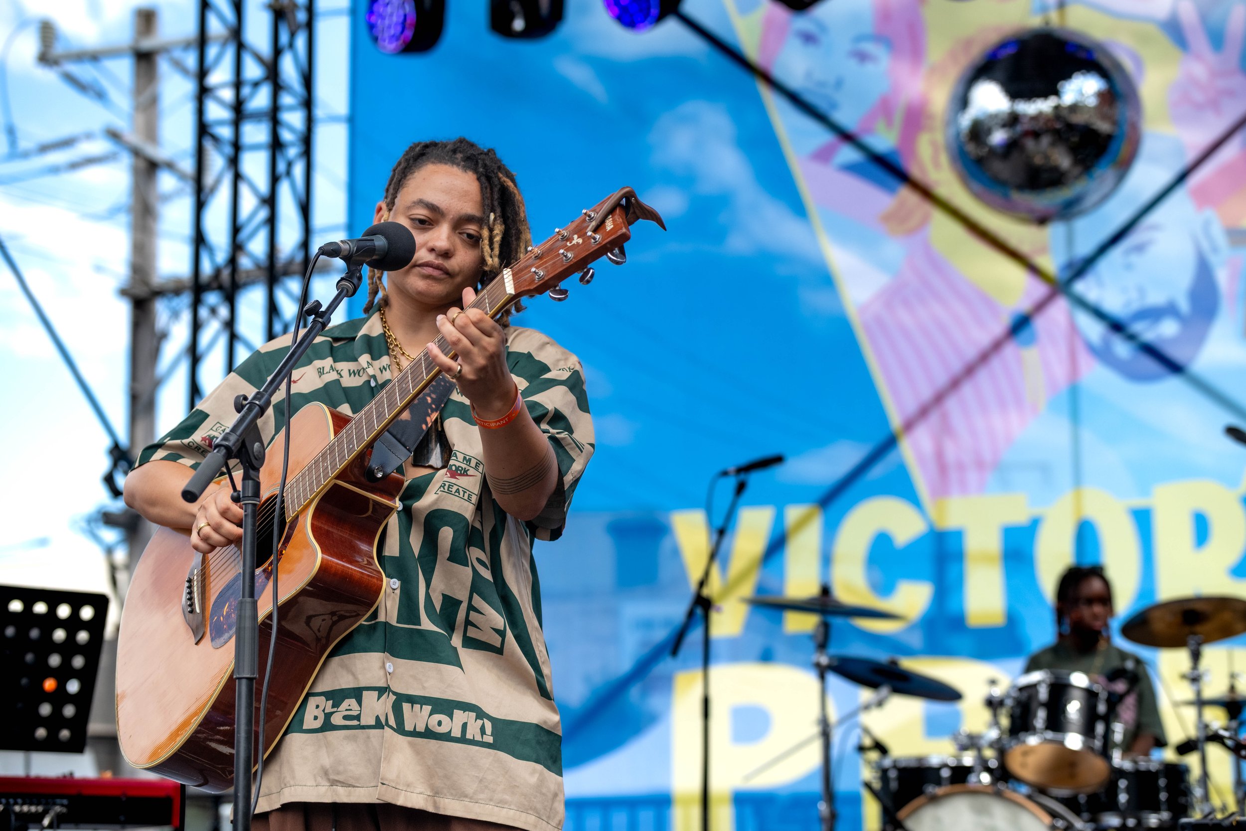 Malaika Mfalme plays the guitar.