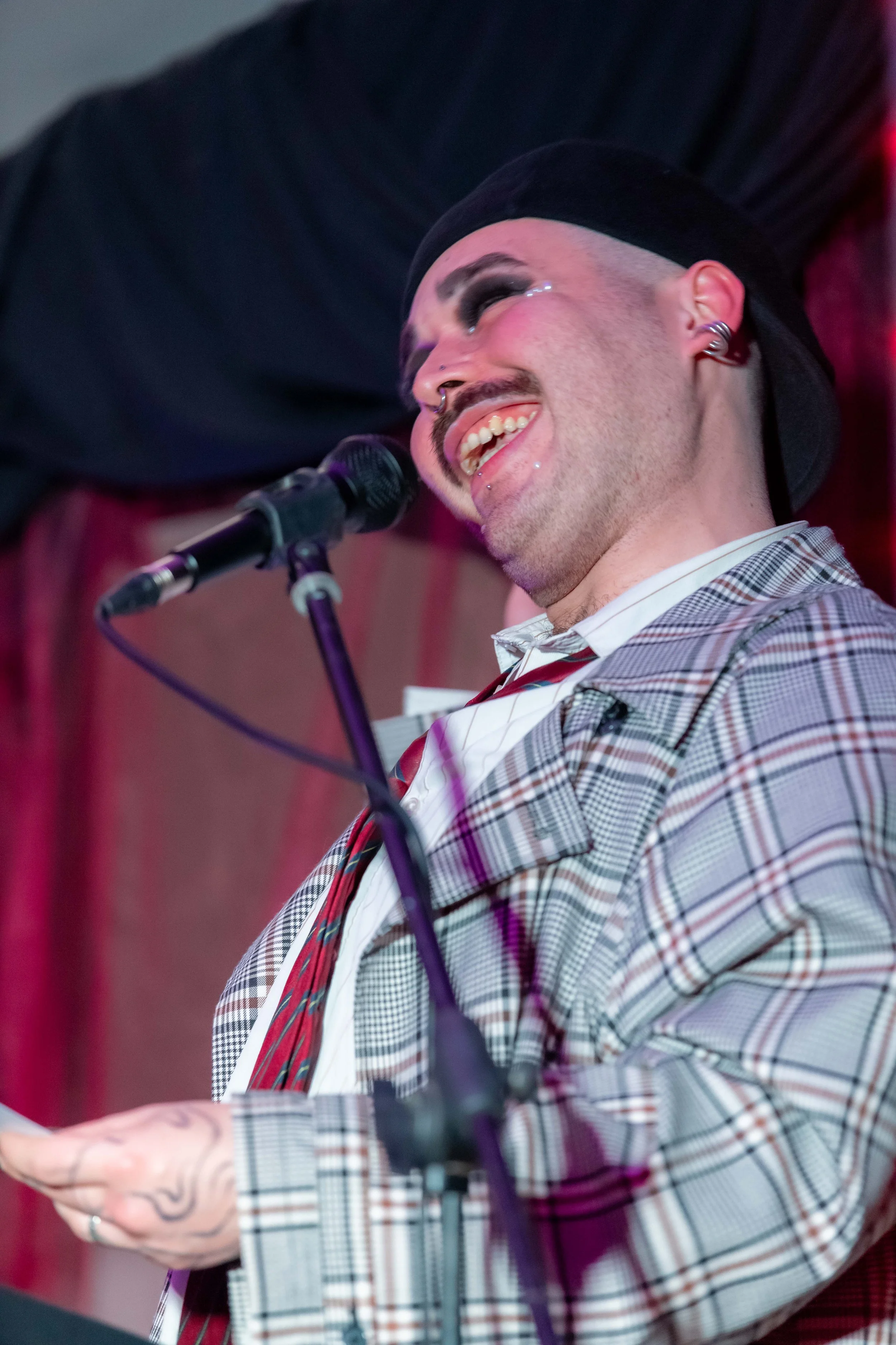 Bo Bickmore laughs into a microphone.