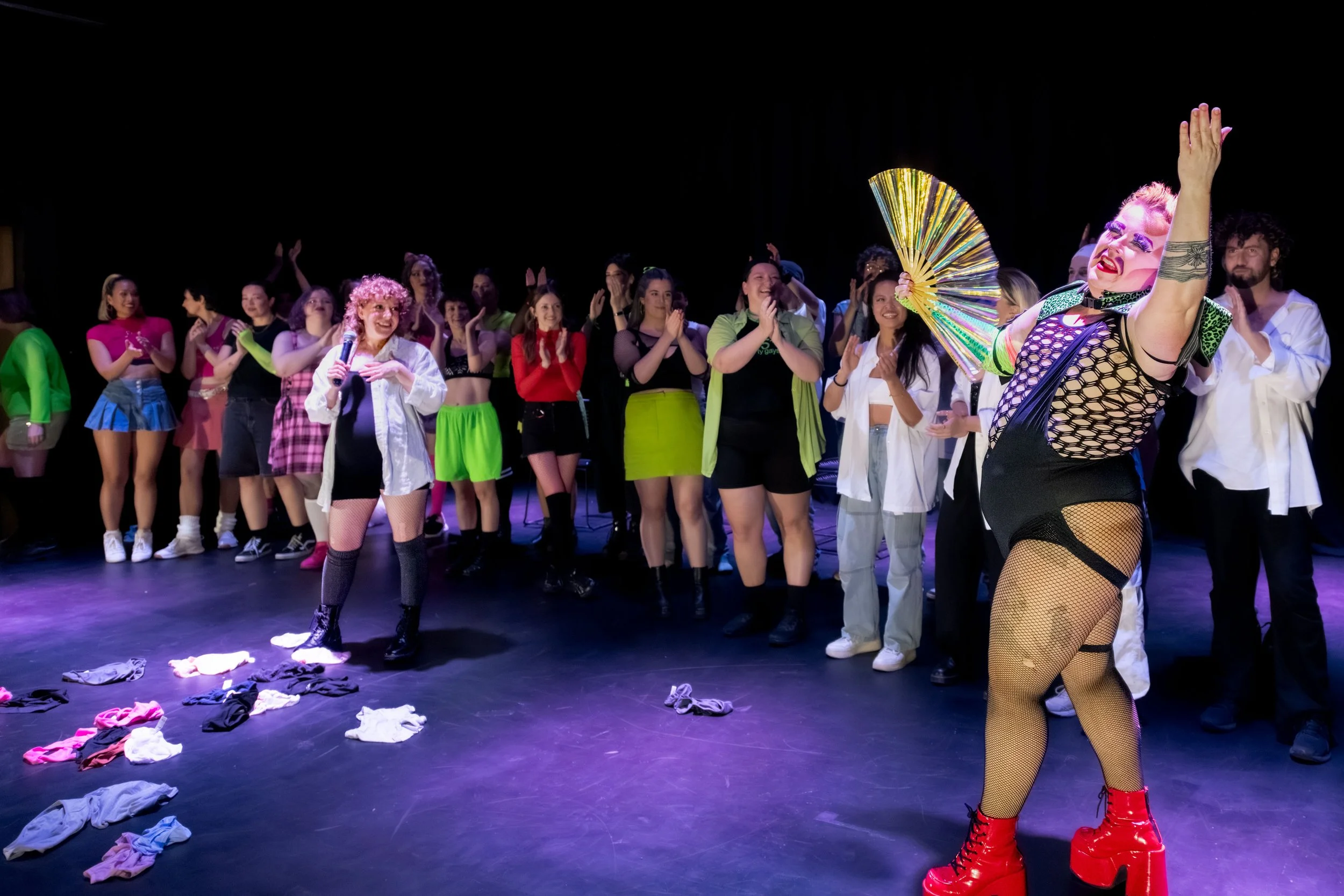The dance academy with Jesse Dean fanning themselves, waving at the audience.