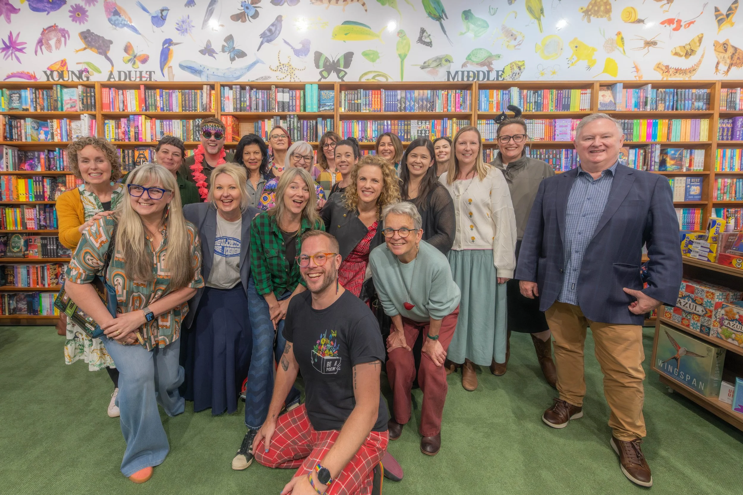 A lot of illustrators gather together with Michael Earp in front. They smile for the camera.