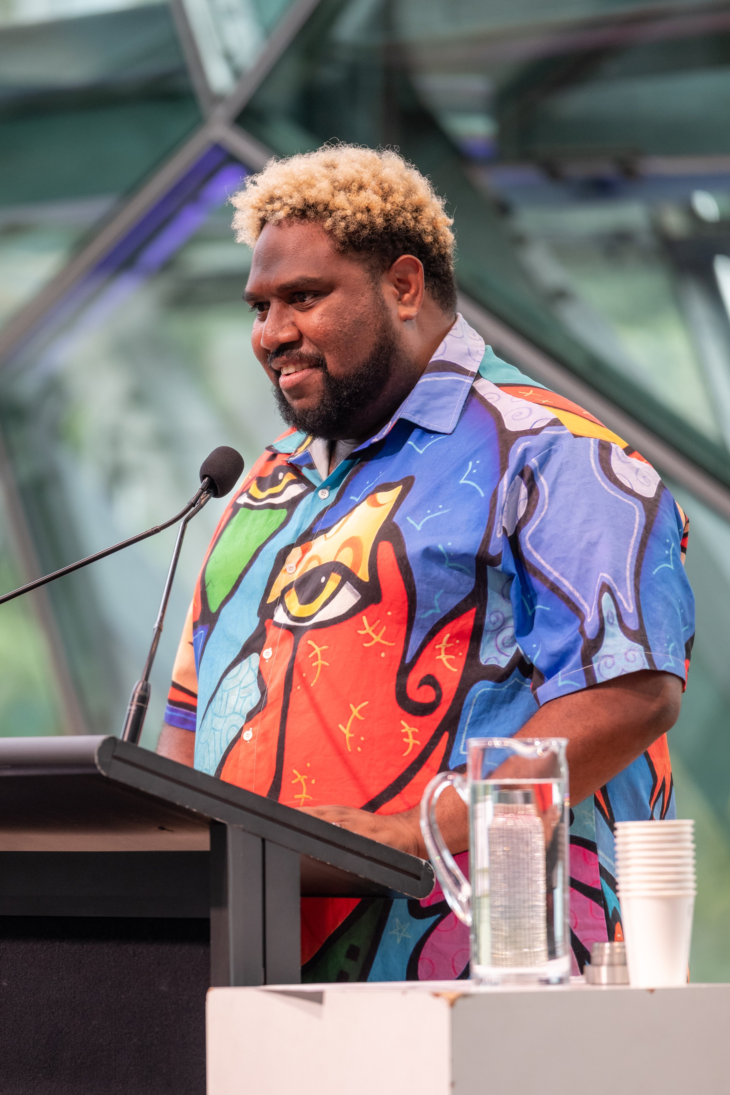 Jay Wymarra smiles at the audience.