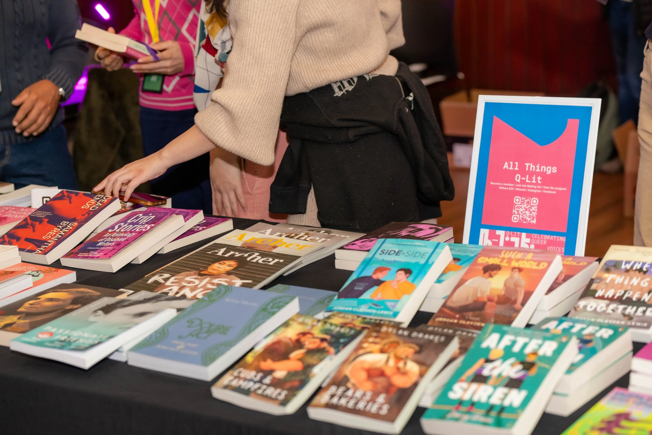 A display of books for sale from Hares & Hyenas, including Archer magazine.