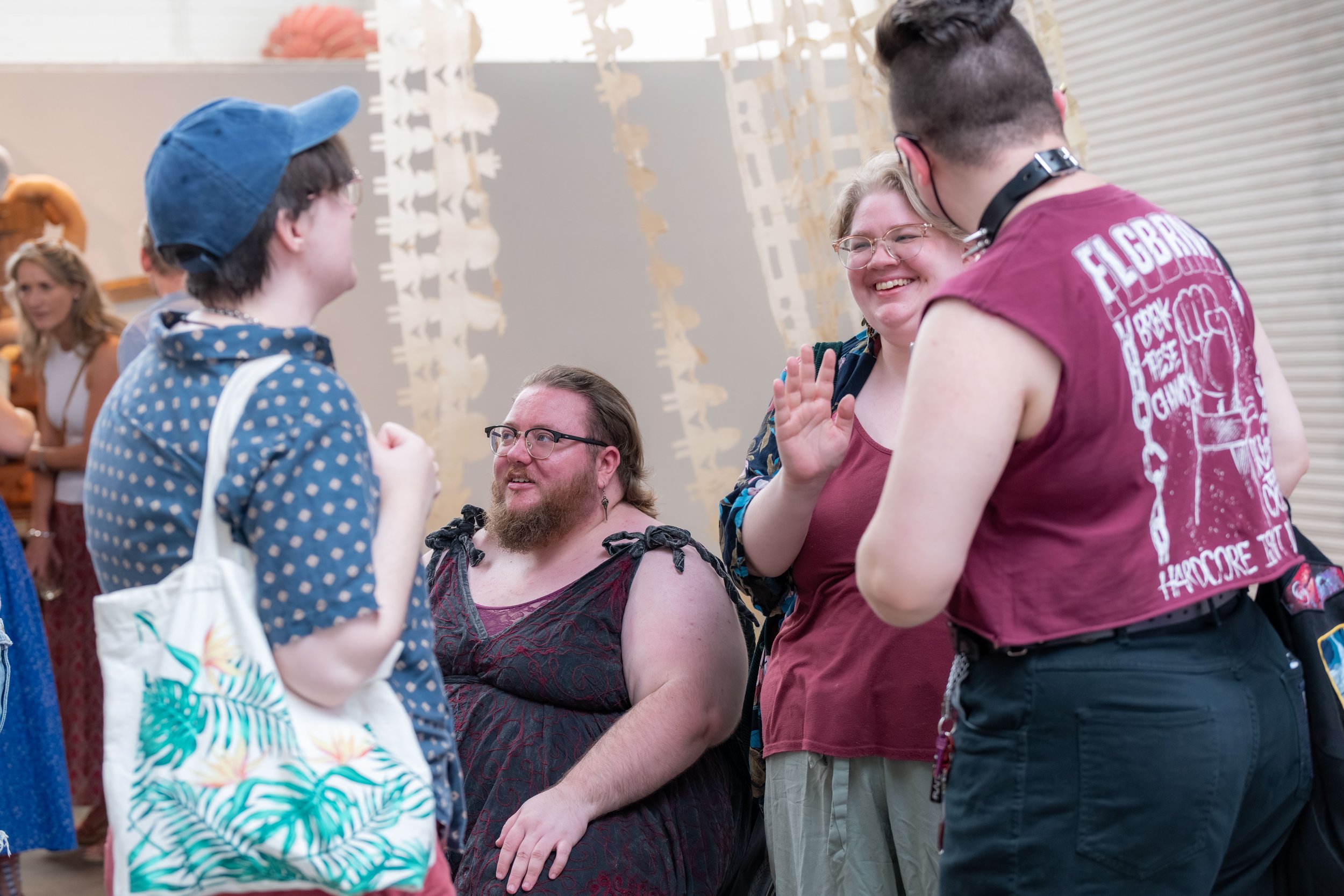 Bramble Karvinen is surrounded by people chatting.