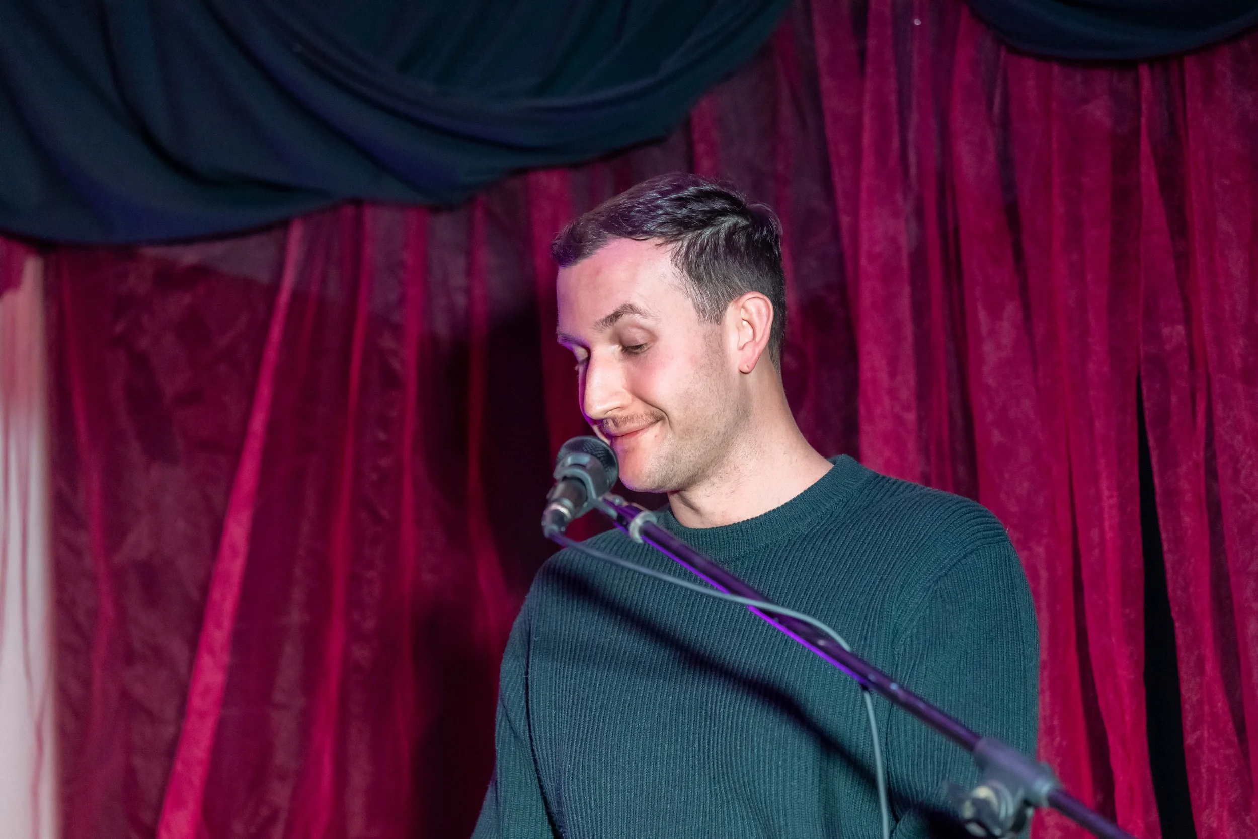 Jordan Clayden-Lewis speaks into a microphone.