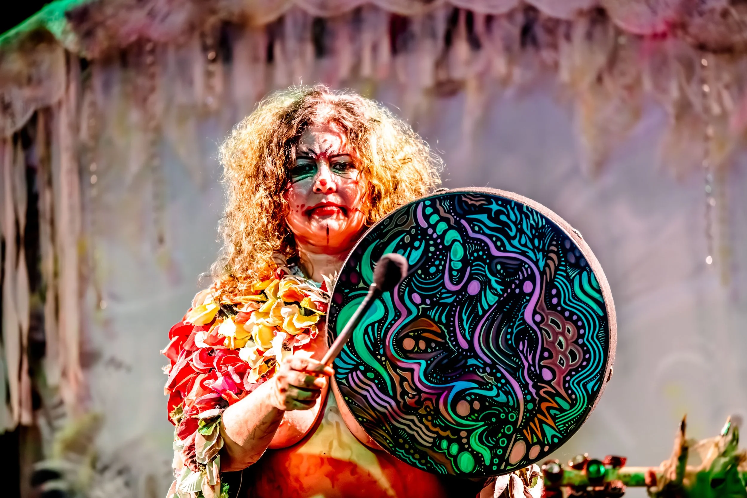 Jessie Ngaio beats an ornately painted drum.