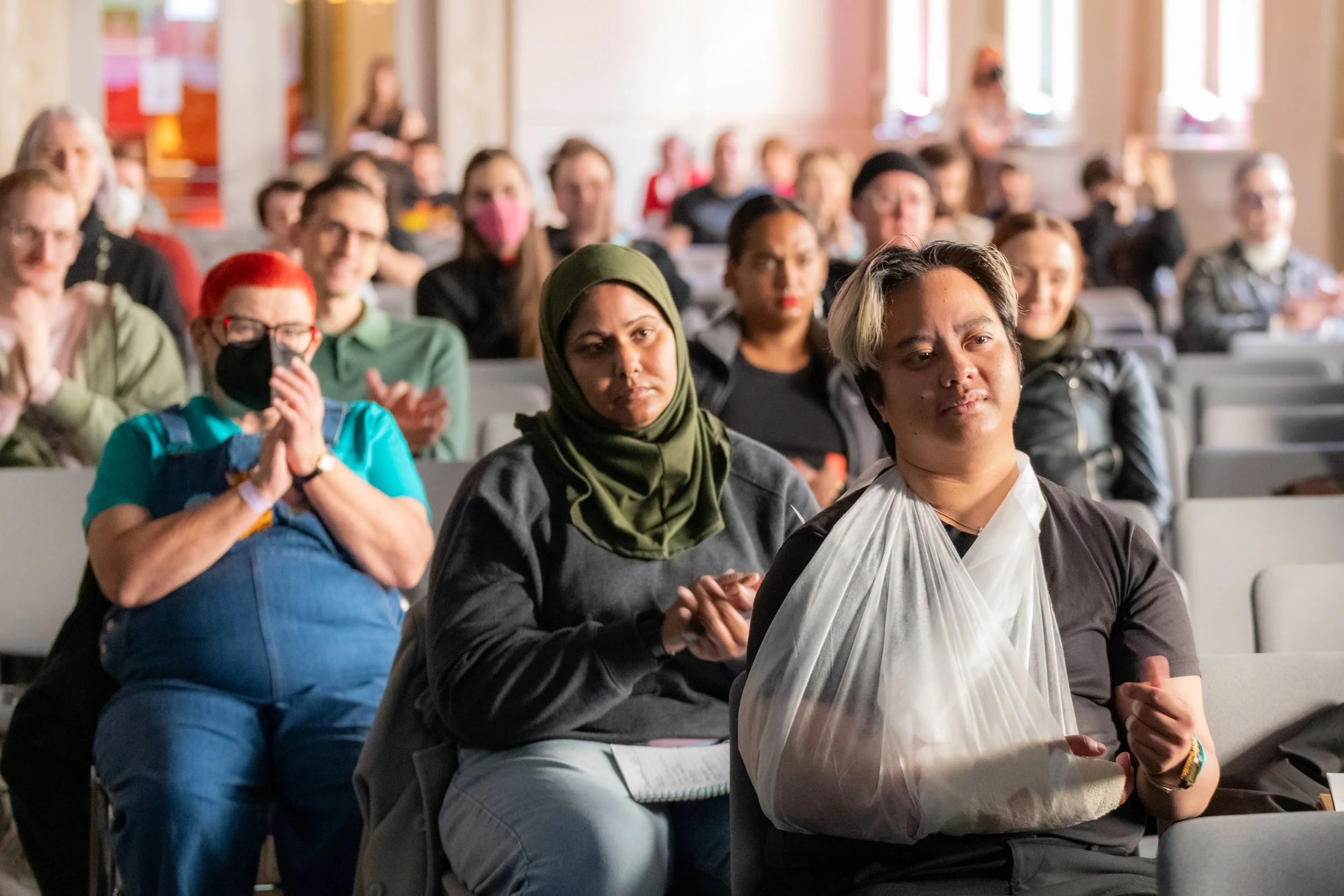 Audience members clapping.