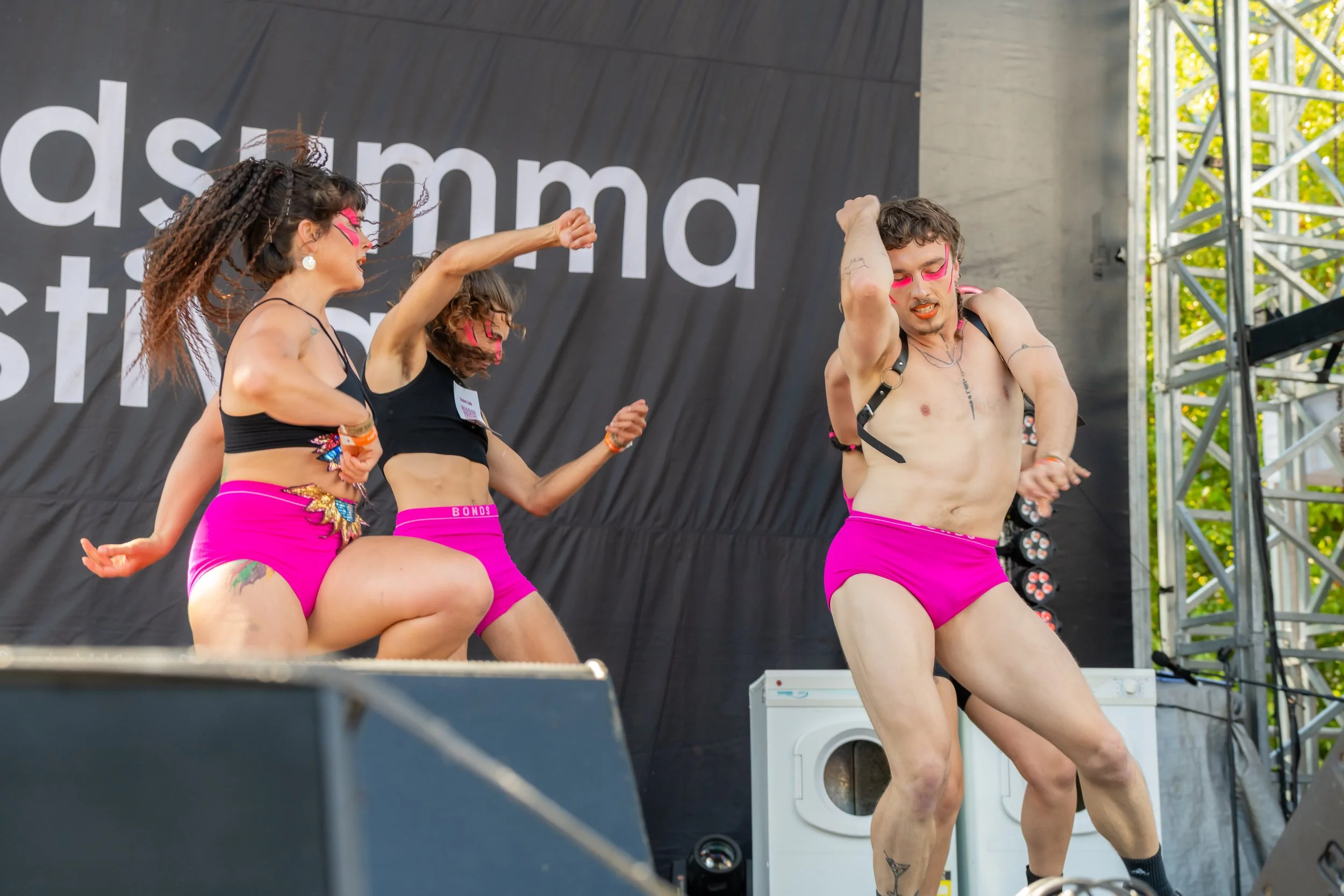 Hot and Heavy dancers dance across the stage amid washing machines.