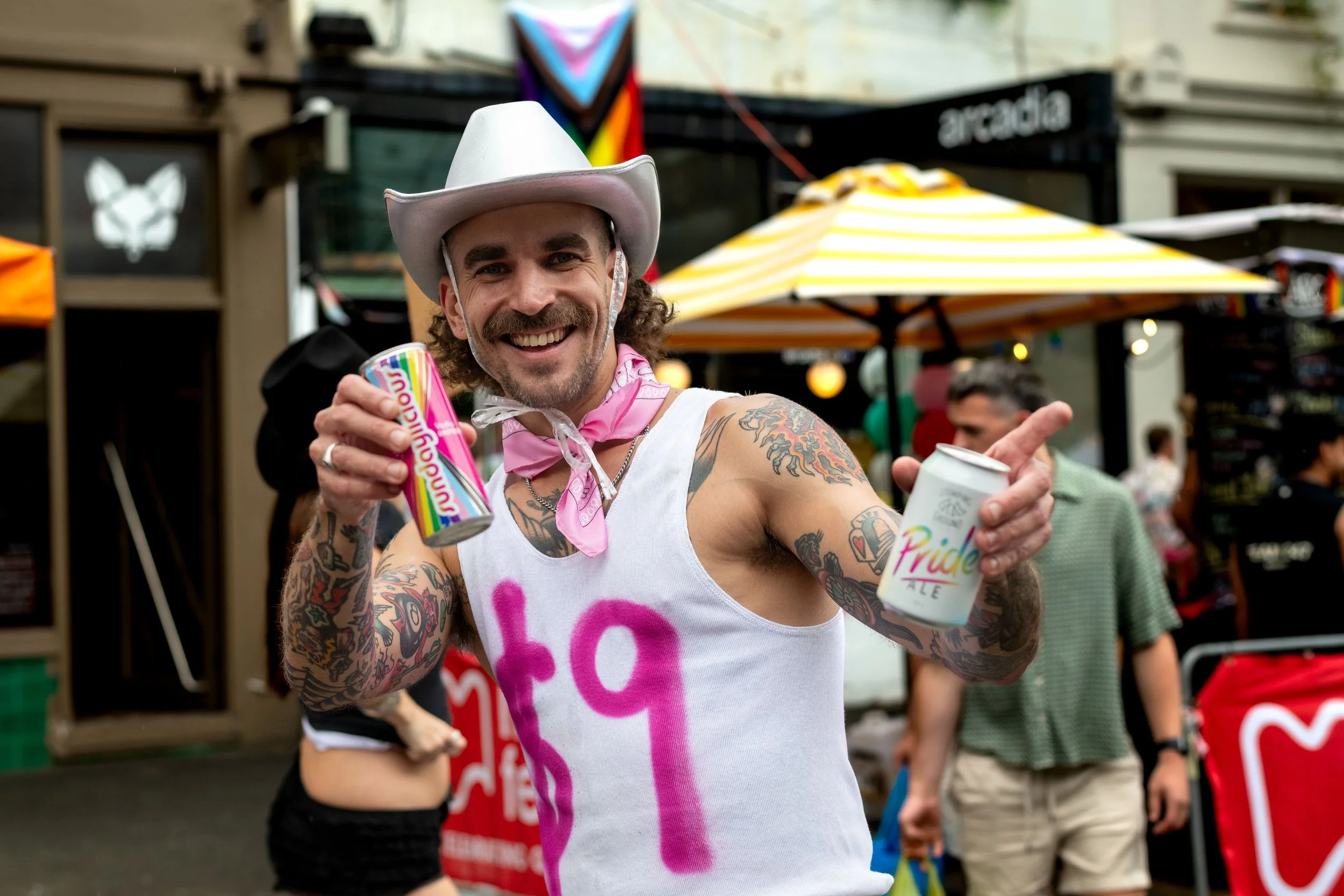 A human in a cowboy hat selling drinks.