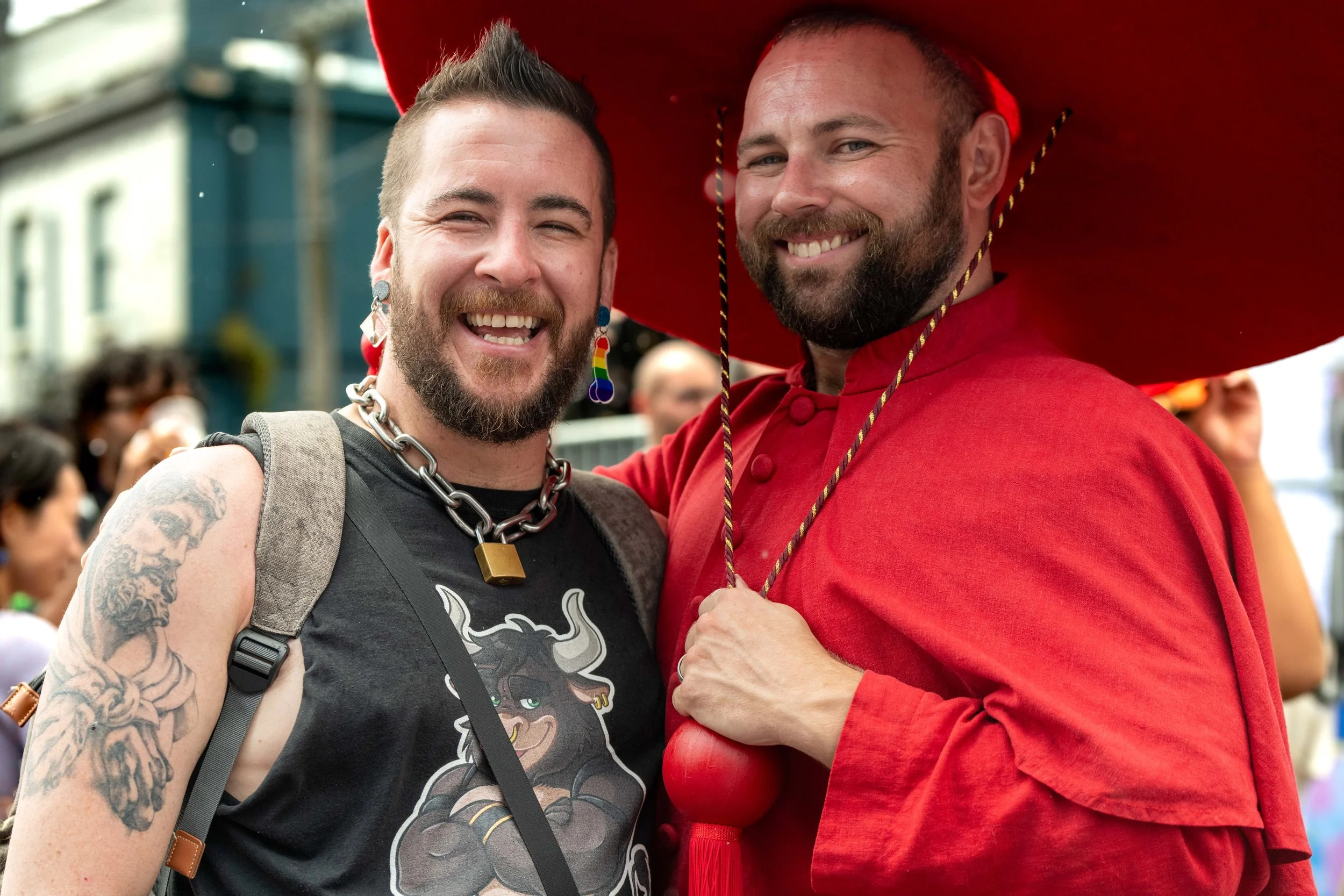 Two humans smile for the camera. One is wearing a Cardinal red uniform.