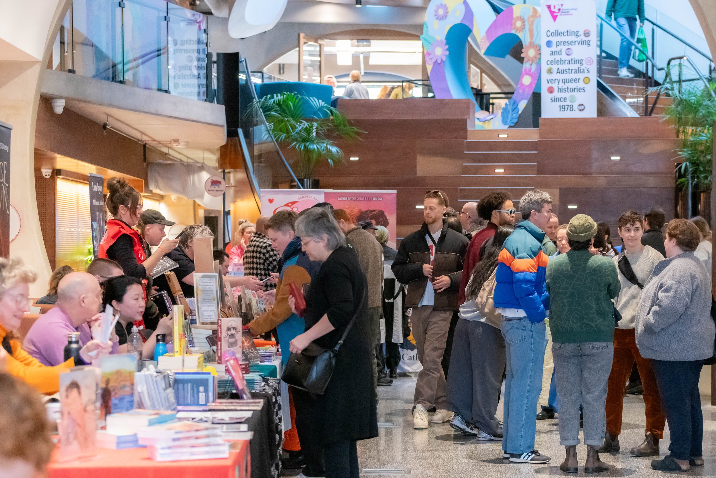 A large crowd of humans perusing book stalls.