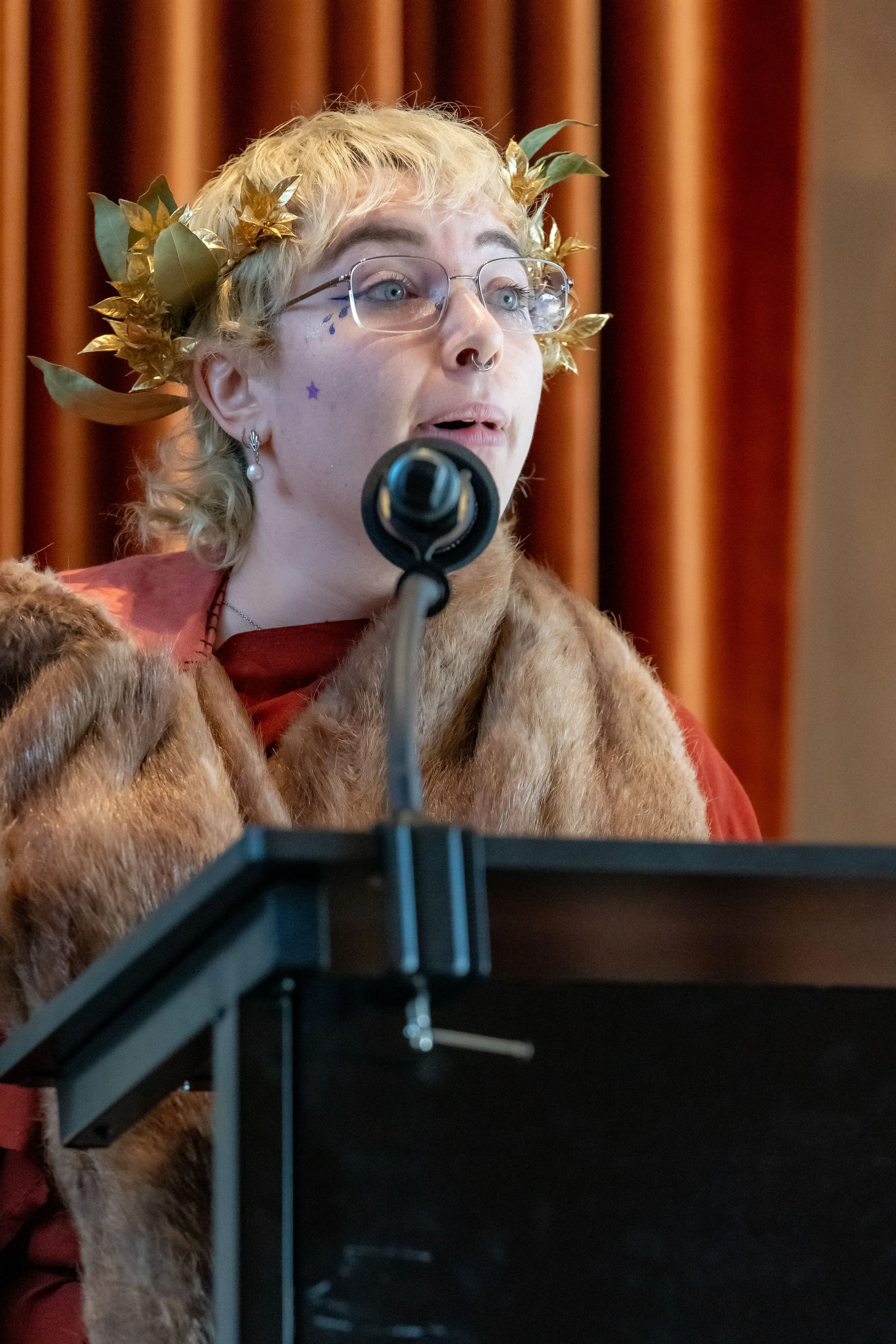 Tobias Fulton in costume speaks into a microphone.