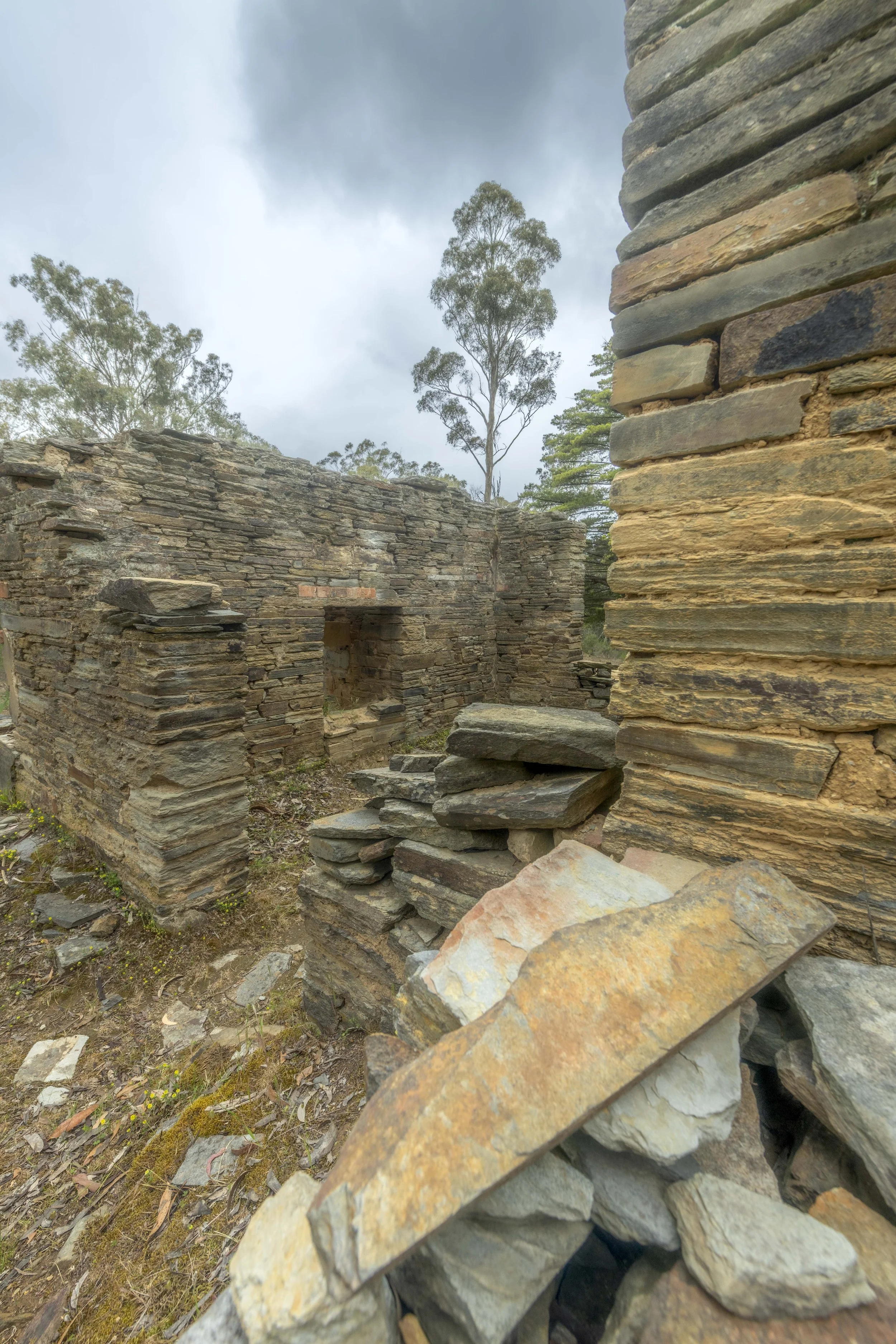 A dilapidated stone building. Stone is stacked and falling apart.