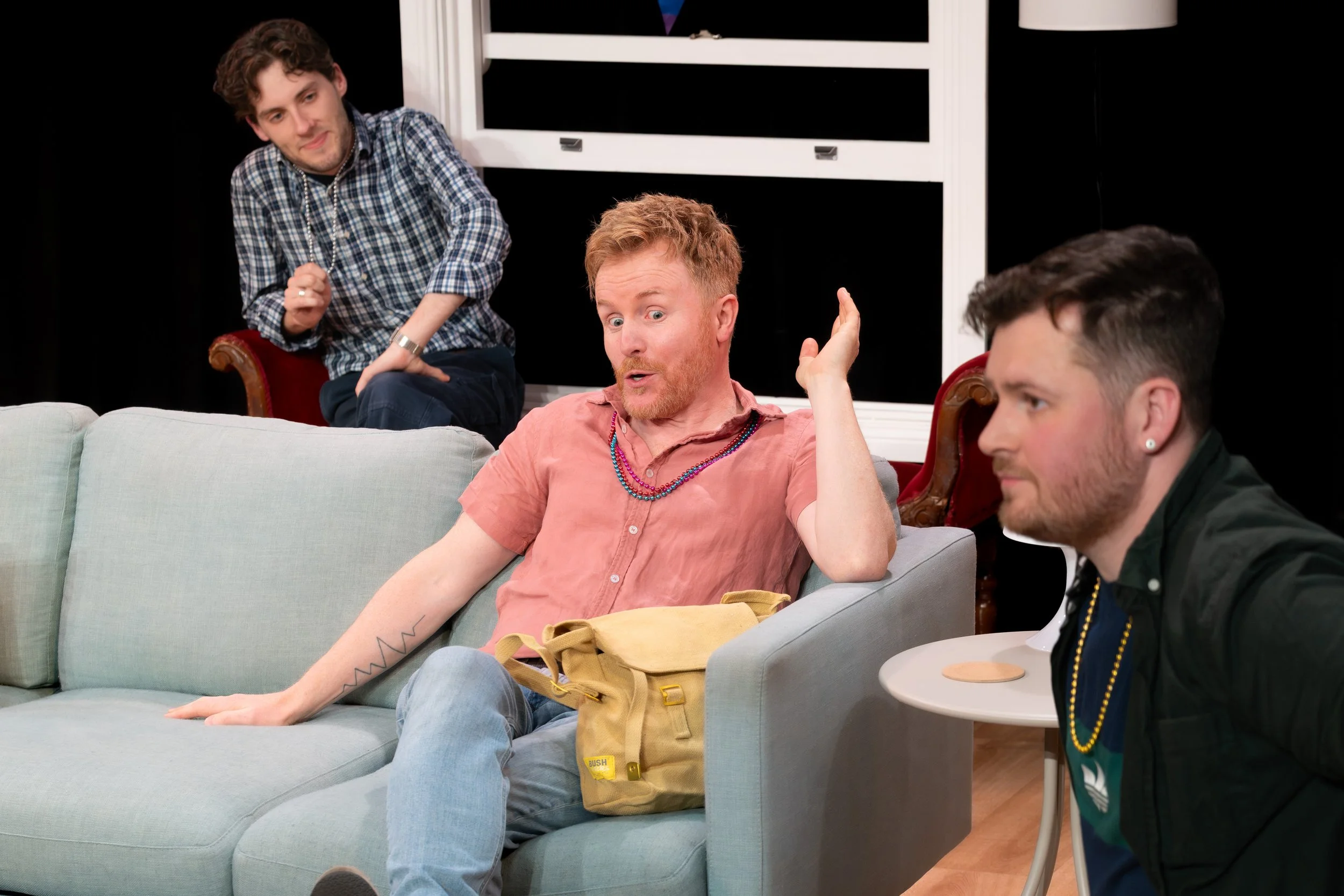 A human in a pink shirt makes a face.