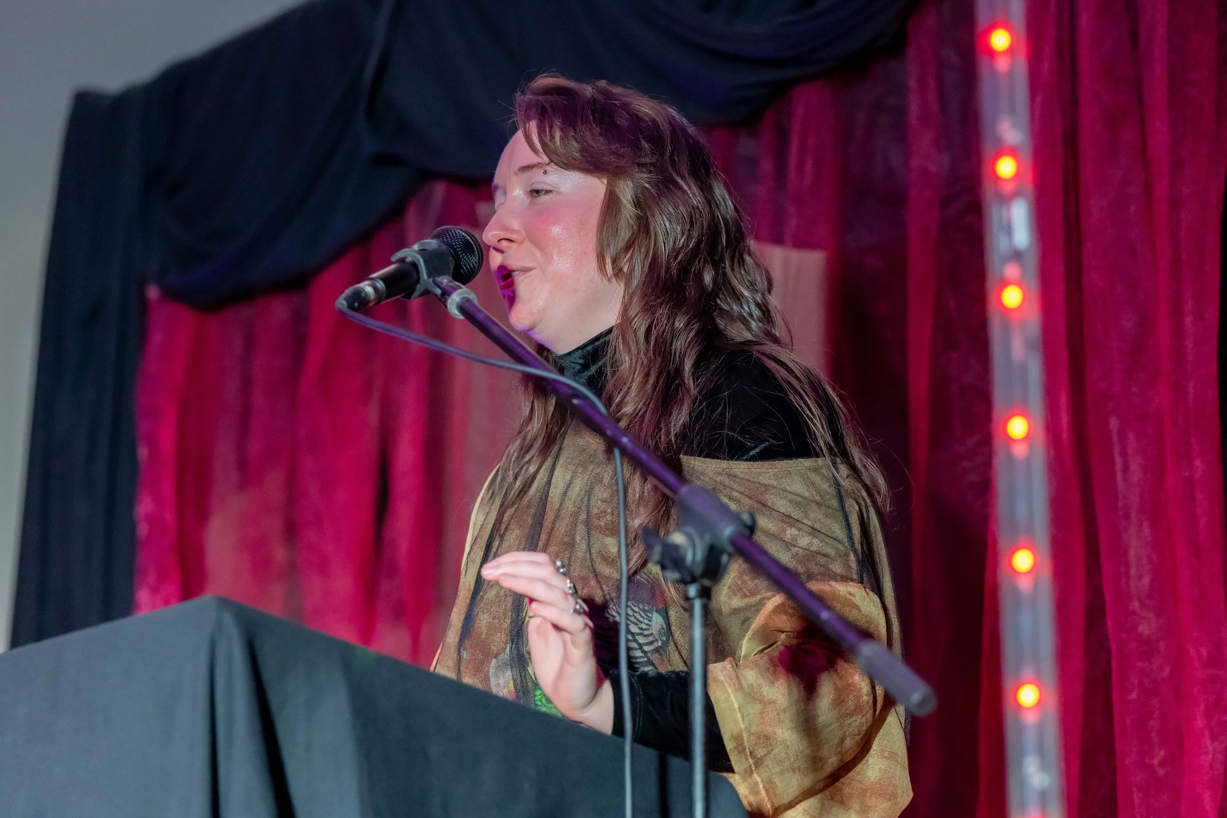 Emily White speaks into a microphone.