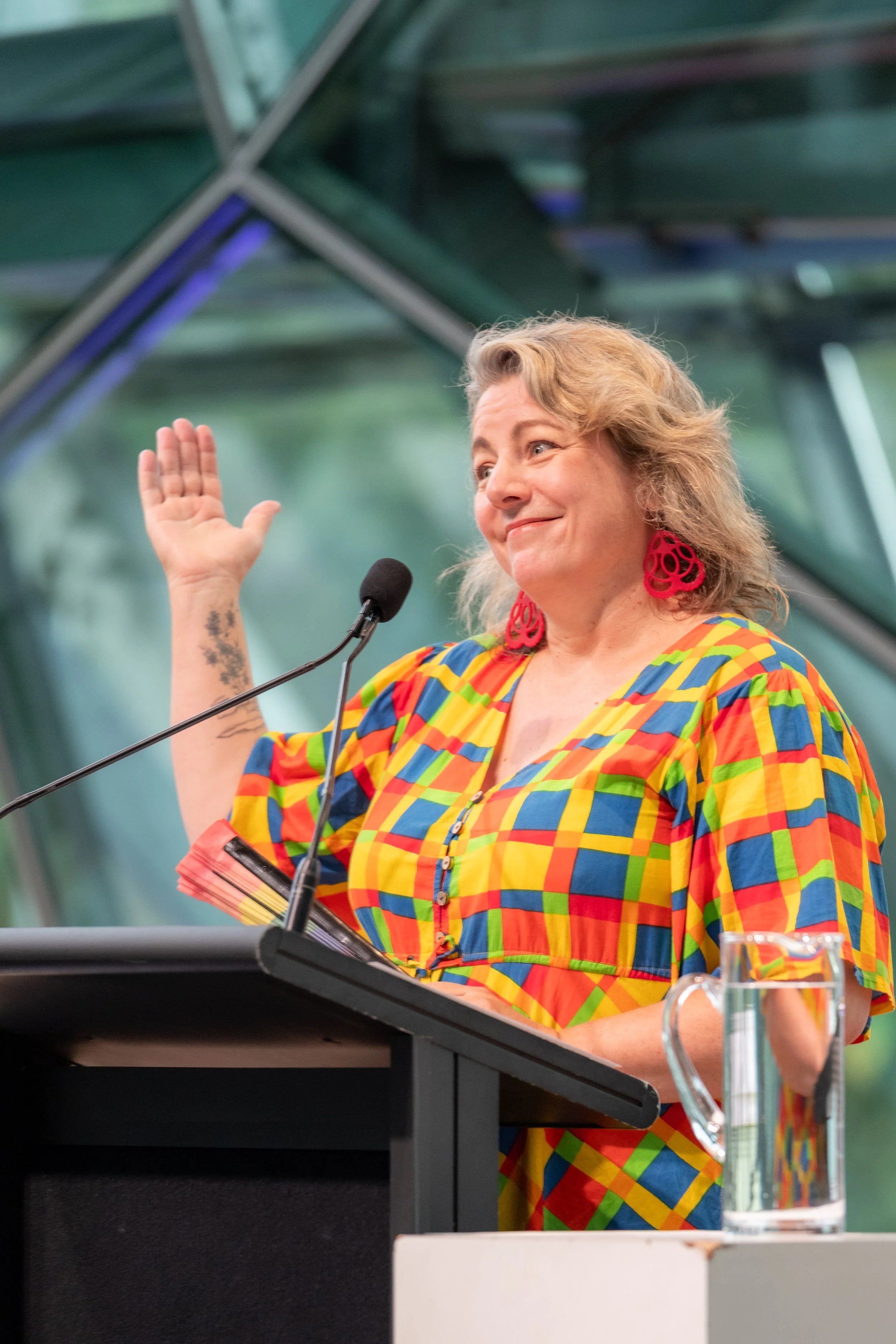 Nelly Thomas smiles and raises an arm in the air.