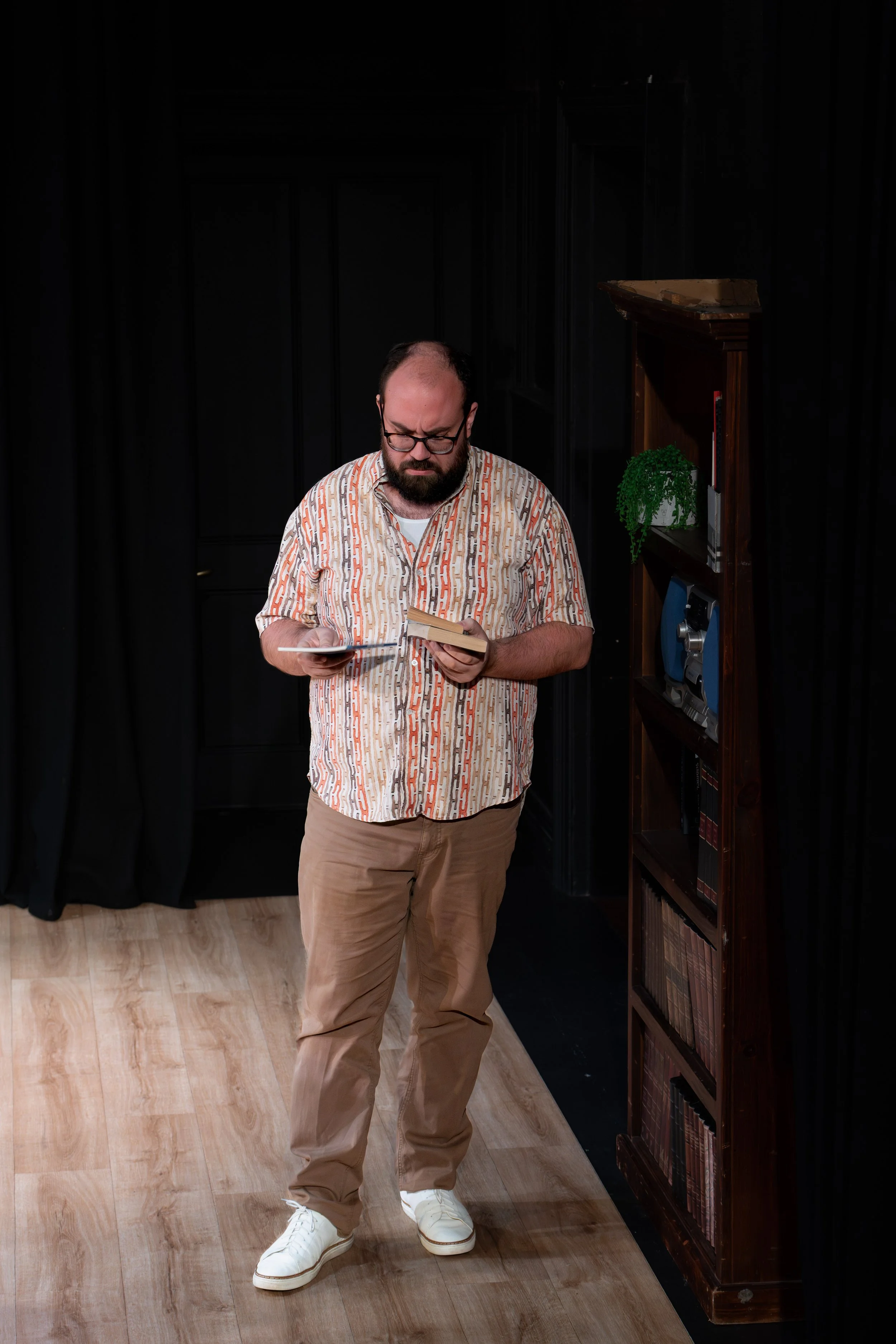 A human looks at a couple of books.