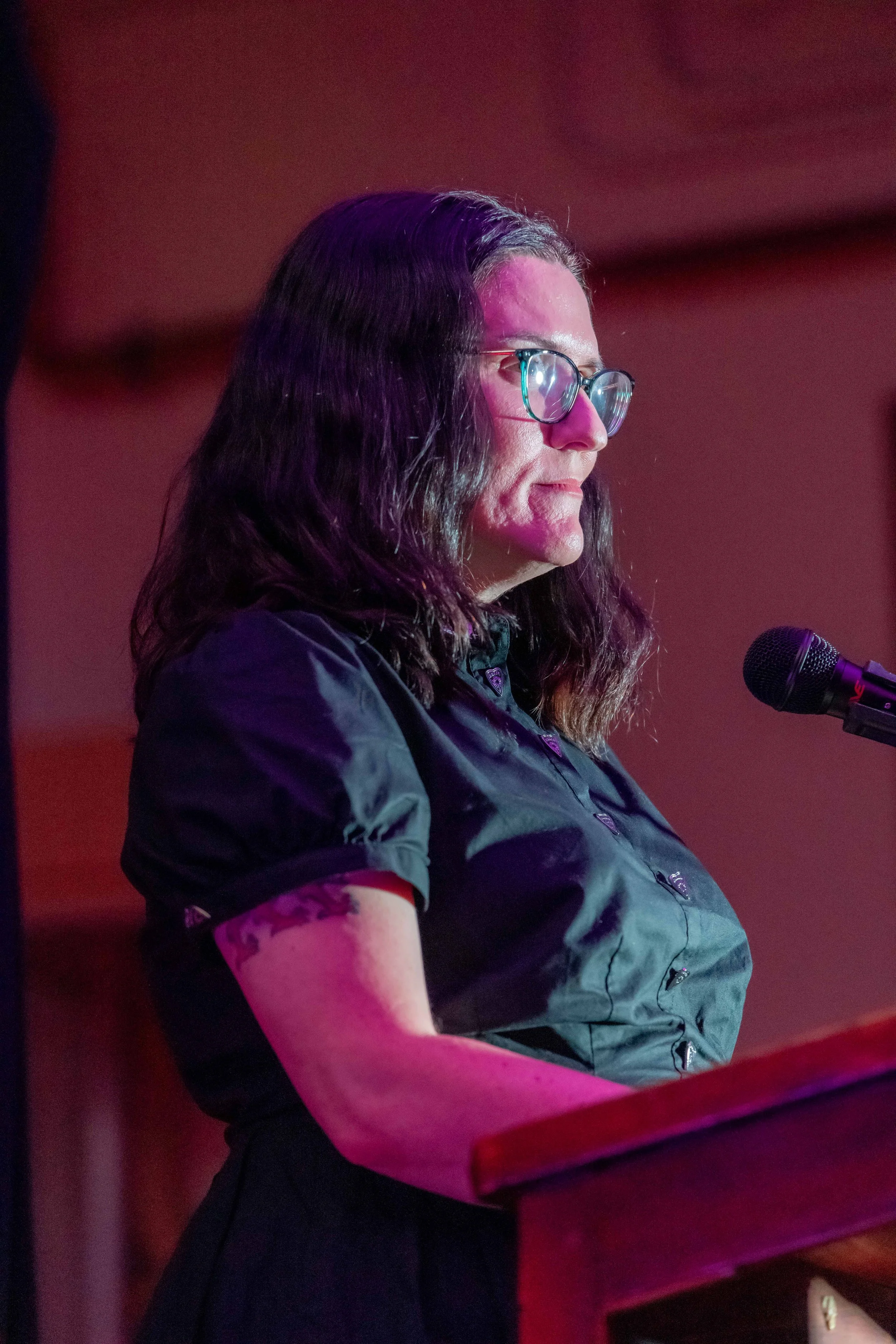 Tara Calaby stands behind a lecturn.