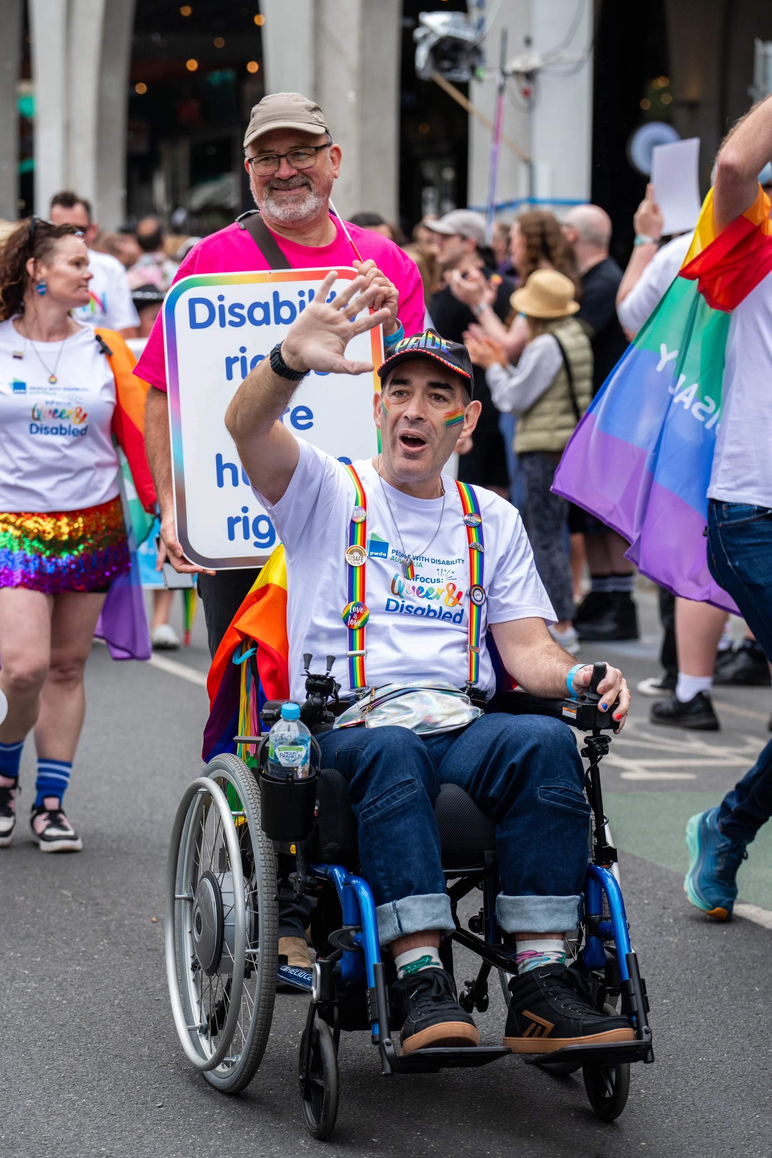 A human in a wheelchair waving.