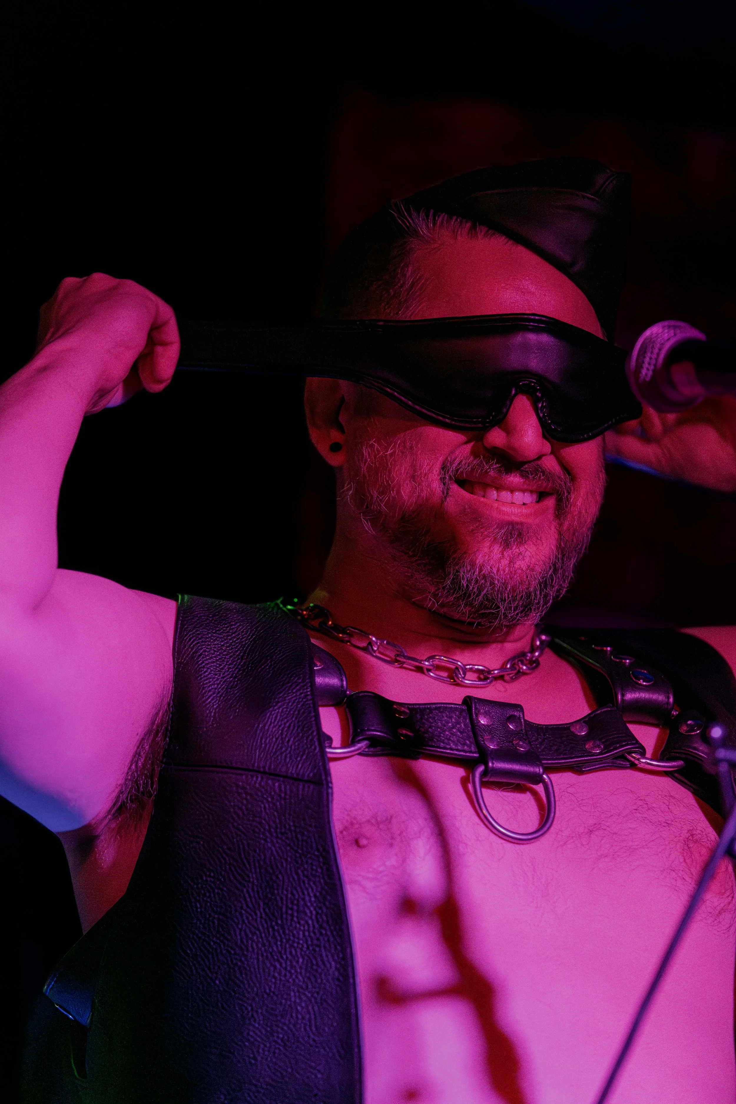 Andrew Rose puts on a leather blindfold.