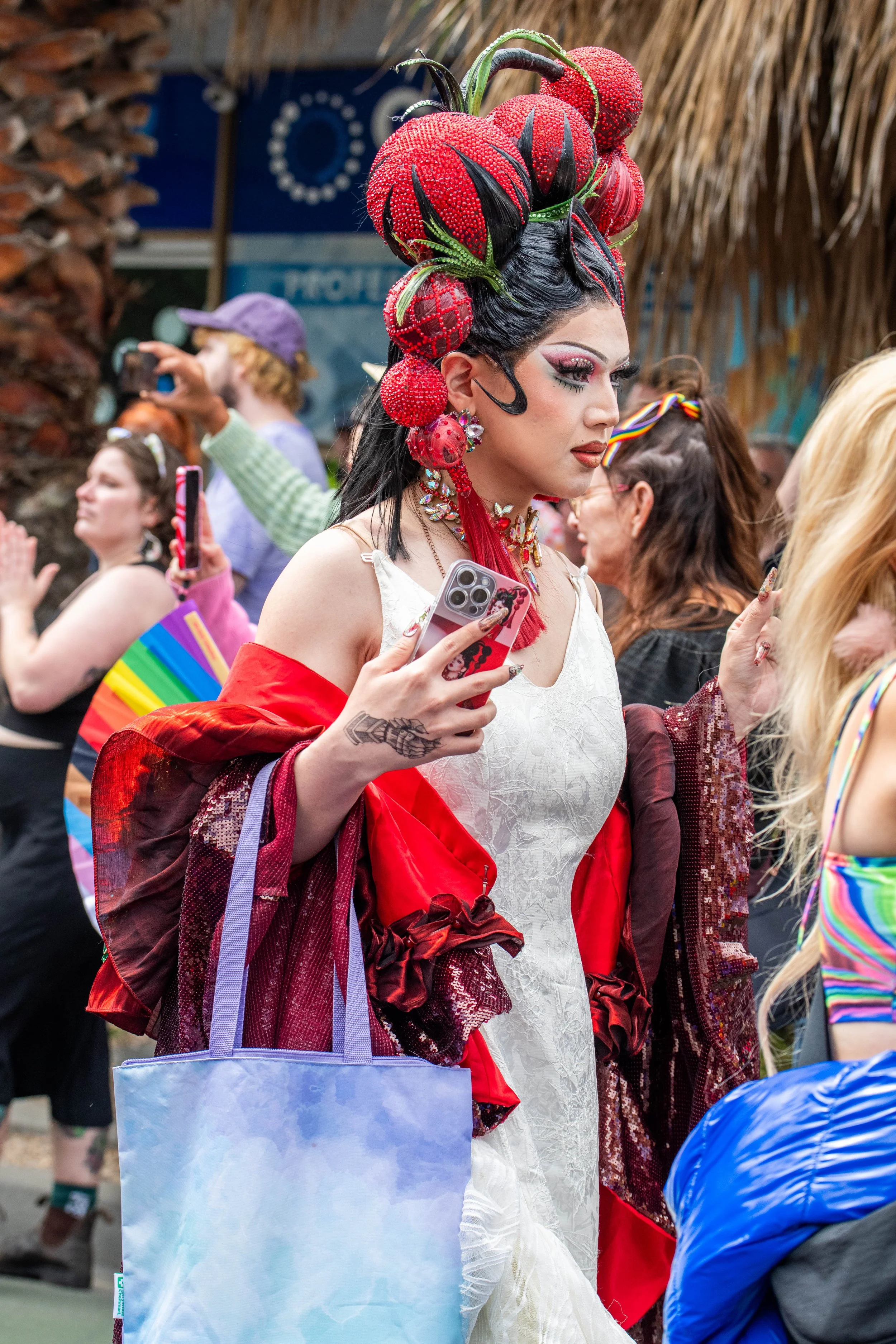 A human wearing a white dress and red wrap.