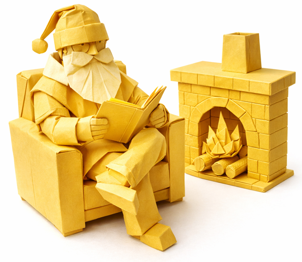 Origami Santa reading a book by the fire.