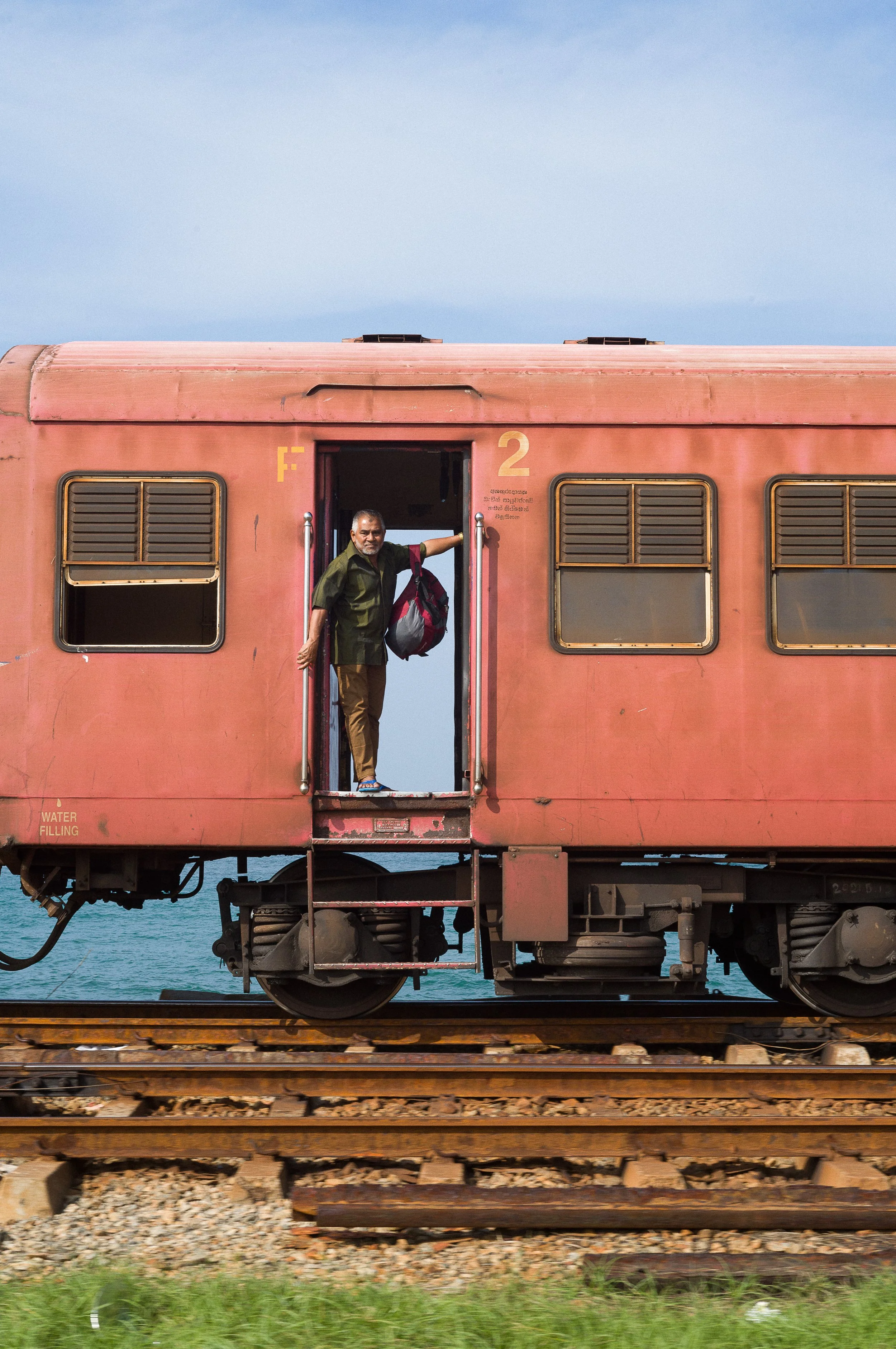 Man in Sri Lanka looking out of a train