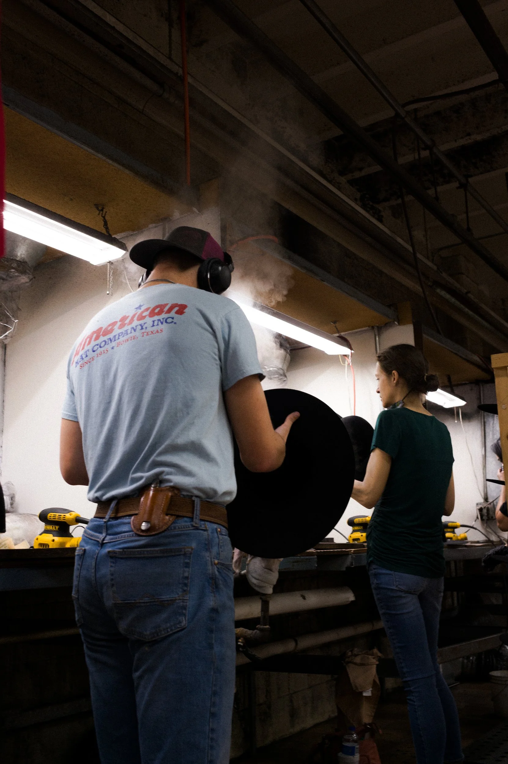 People working in the american cowboy hat workshop.