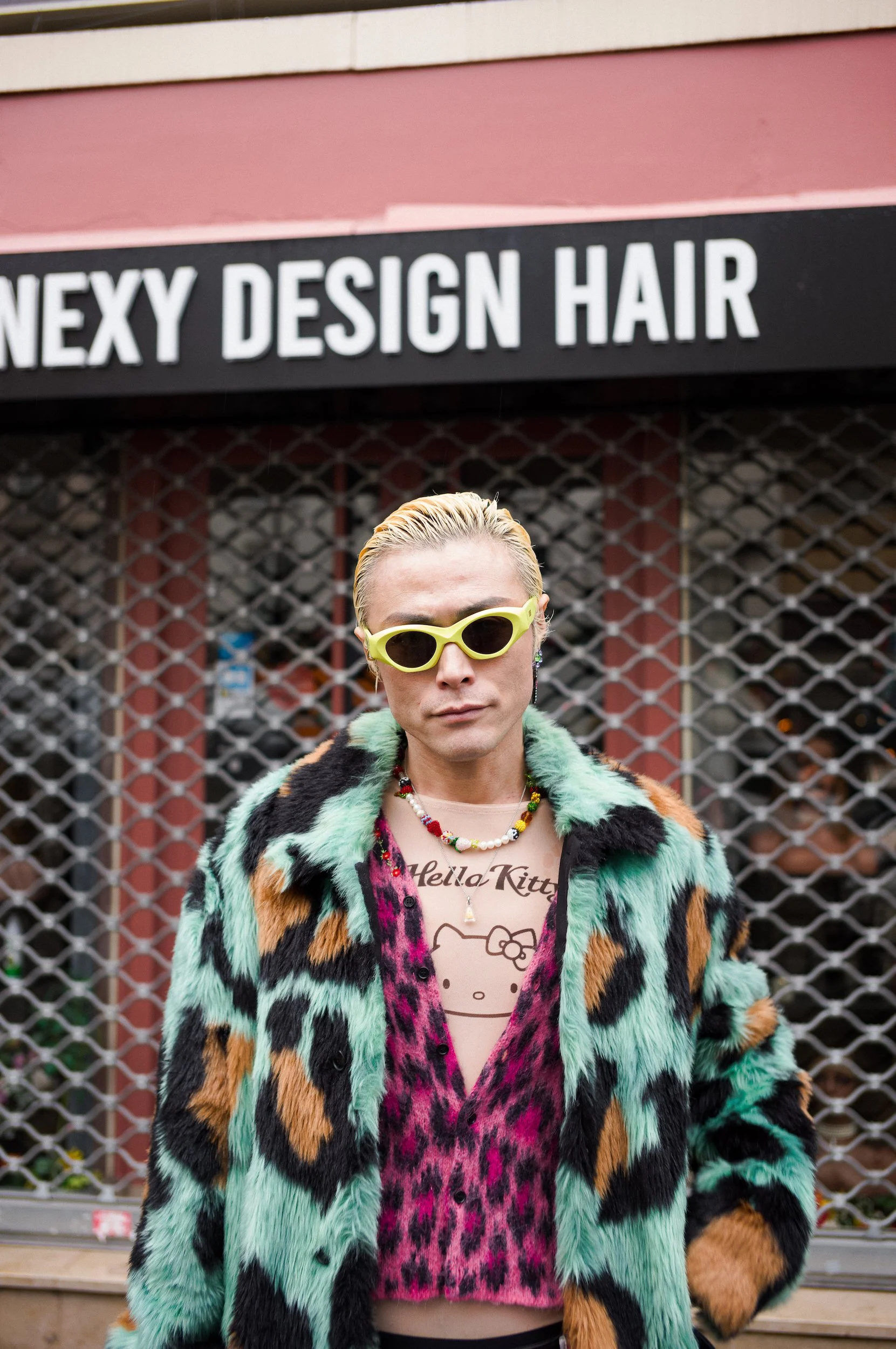 At Paris Fashion Week, Yu Matsui wearing a colorful fur coat, yellow sunglasses, and multiple necklaces