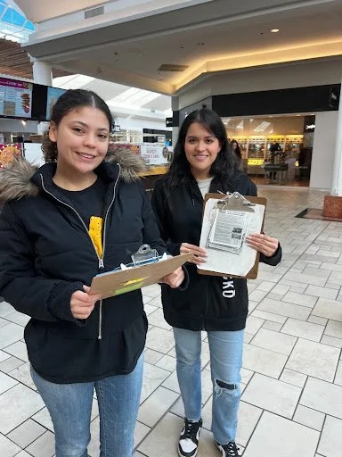 Kaylin and Milagro out in the field recruiting families