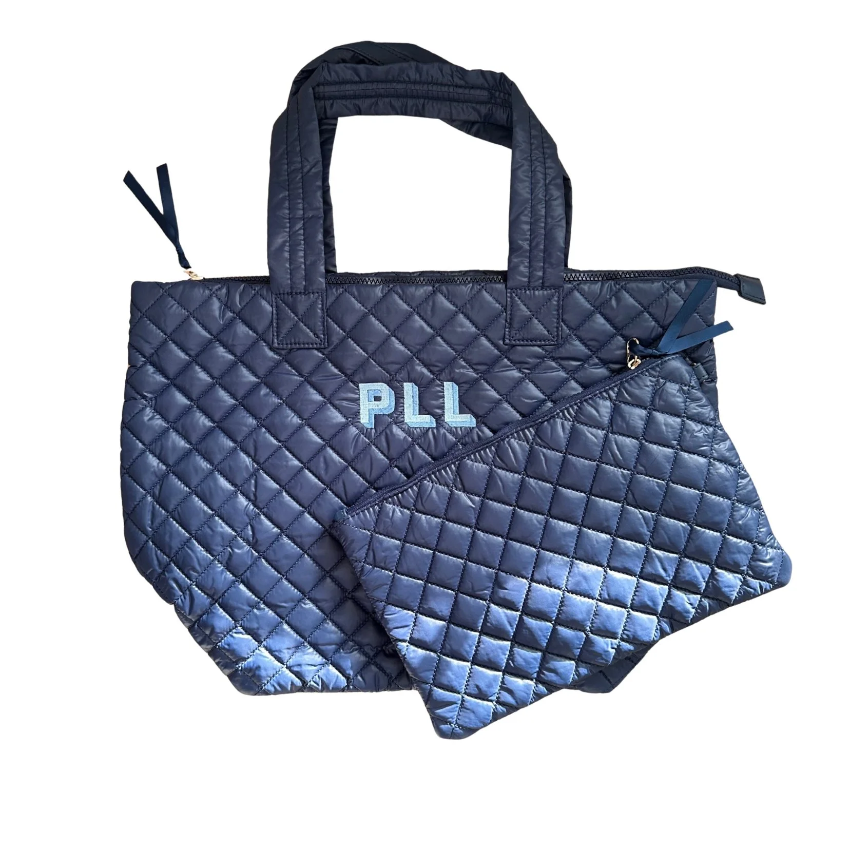 A blue quilted tote bag with monogrammed initials 'PLL' on the front, featuring handles and a zippered closure.
