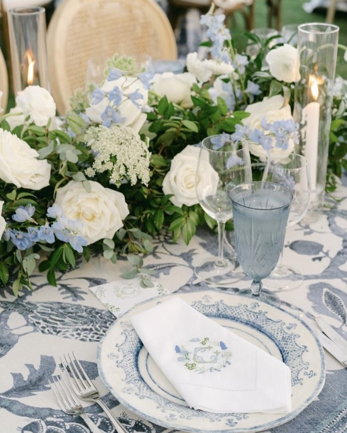 Custom embroidered linens with blue and green wedding crest on a blue and green tablescape