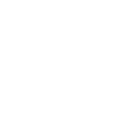 A bathtub with a showerhead and a towel hanging nearby.