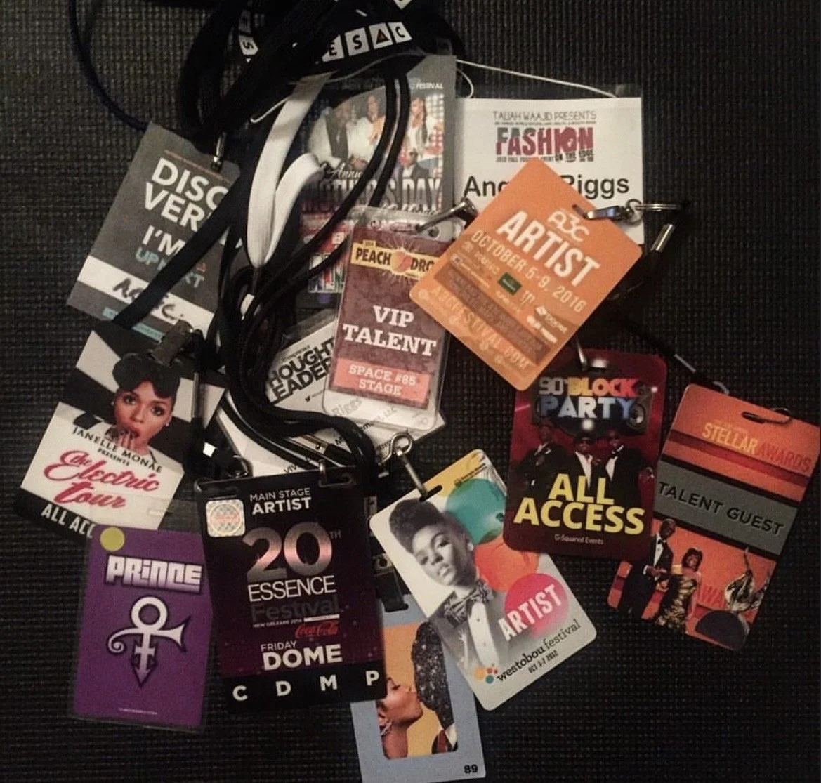 Collection of festival passes, access badges, and lanyards with various images and event titles