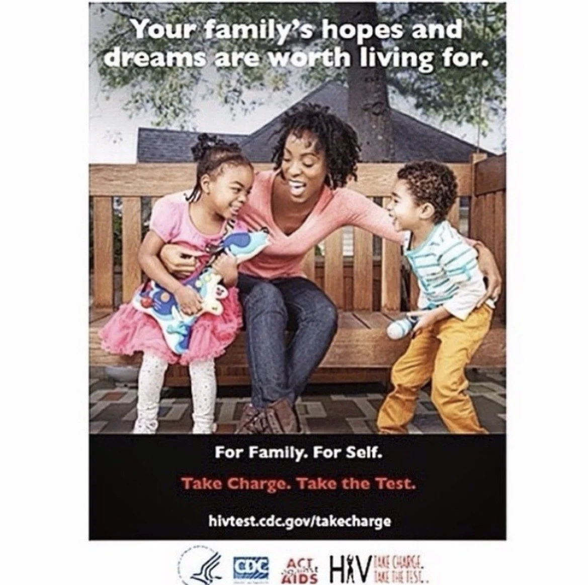 A woman sitting on a wooden bench with two children, one girl and one boy, in an outdoor setting with trees and a house in the background. The girl is holding a colorful stuffed toy, and the boy is holding a microphone. The image promotes HIV testing for families and individuals.