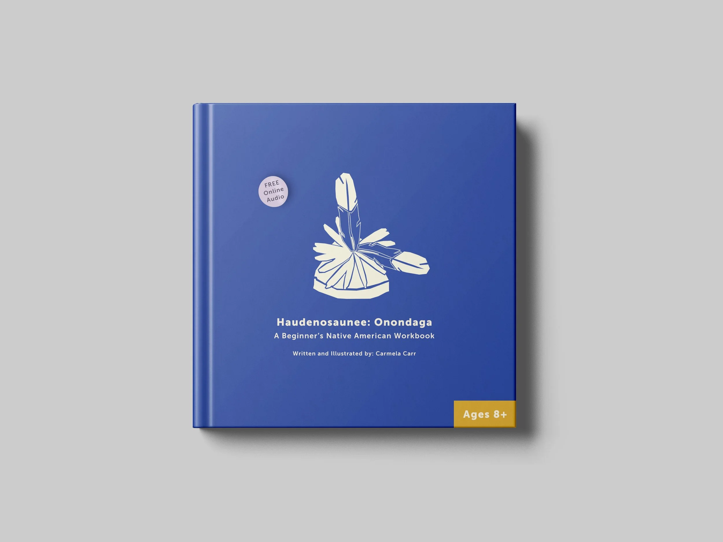 The front cover highlights a graphic of a common feature of the men’s dress, an Onondogan gasdó⋅wä⋅. The bright blue background contrasts the cream graphic, bold, clean type, and the golden rod and light lavender sticker elements. 