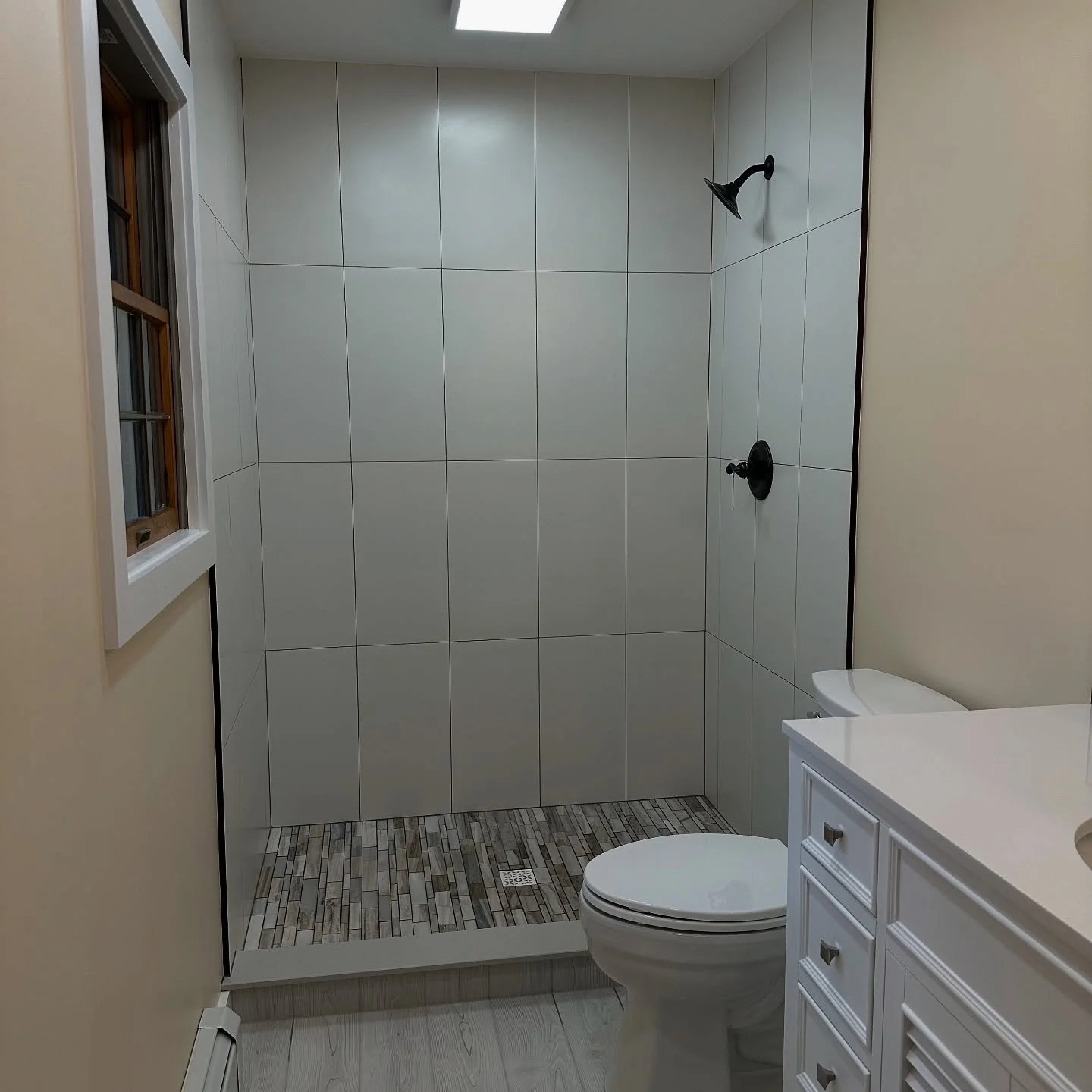 Much needed update! Moved the toilet over and picked up a lot of room in the shower area.