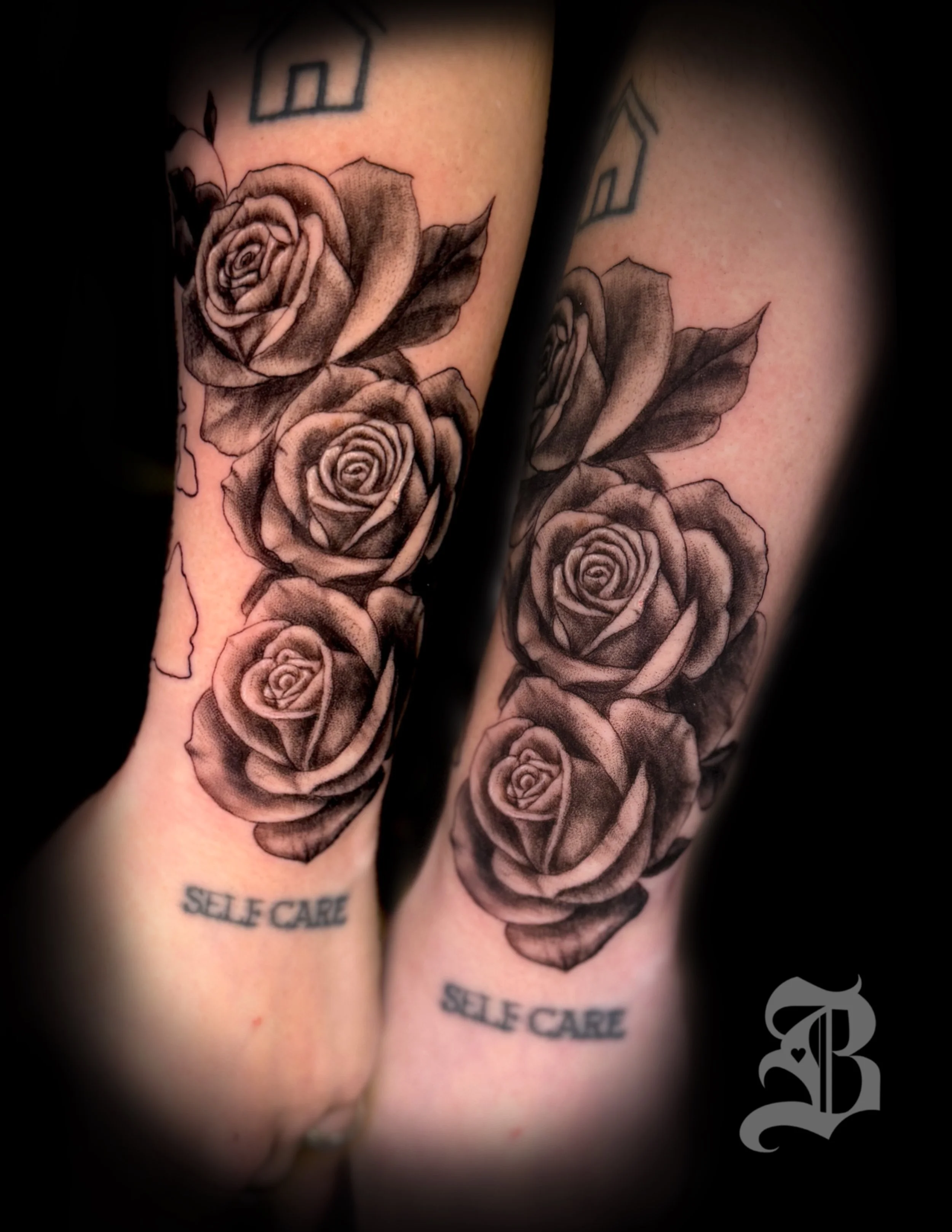 Tattoo of three realistic roses on forearm with the words by Binx inks.