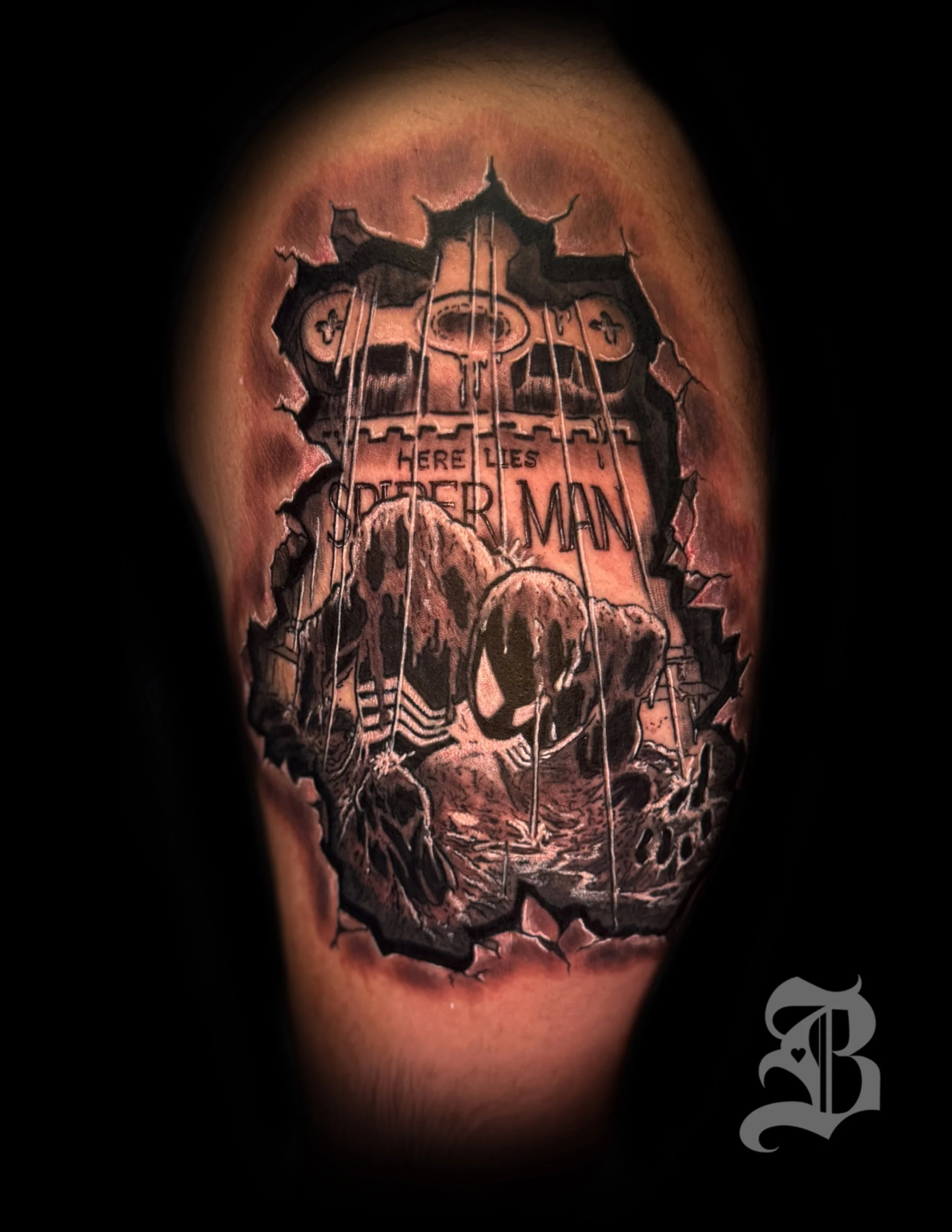 Tattoo of Spider-Man's skull mask with the words 'Here Lies Spider-Man' and a mechanical spider device, appearing as if ripped through the skin by Binx inks.