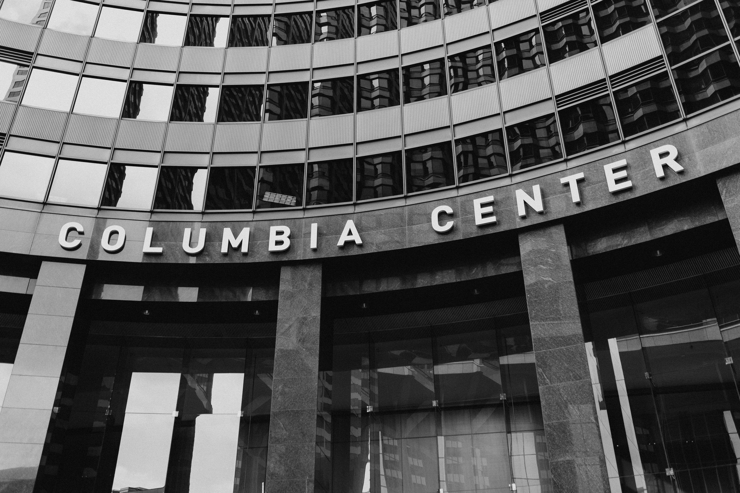  Black and white image of the facade of a building. A sign above the entrance reads “Columbia Center” 