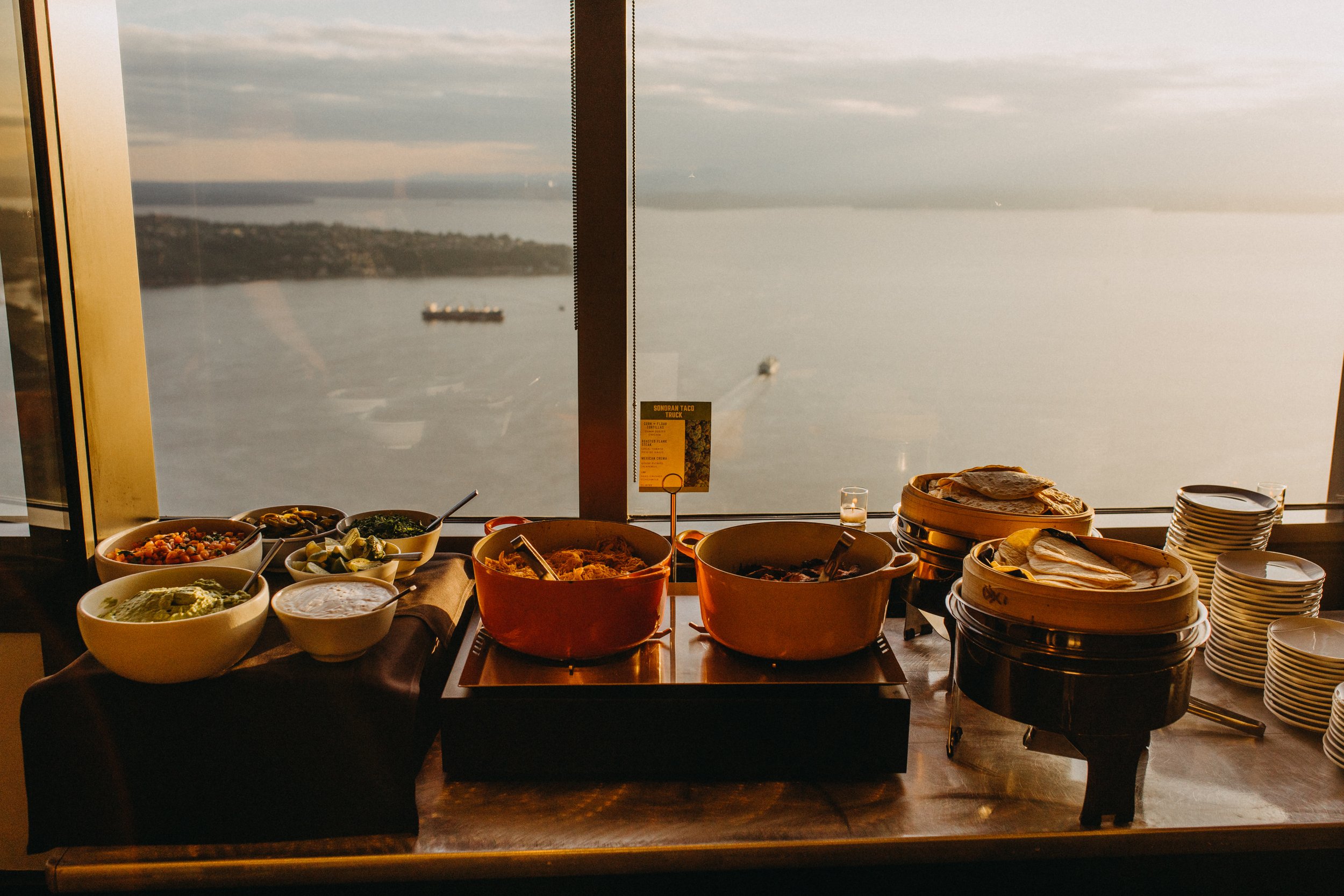  A late-night snack taco bar is set in front of a window overlooking Elliot Bay in Seattle.  