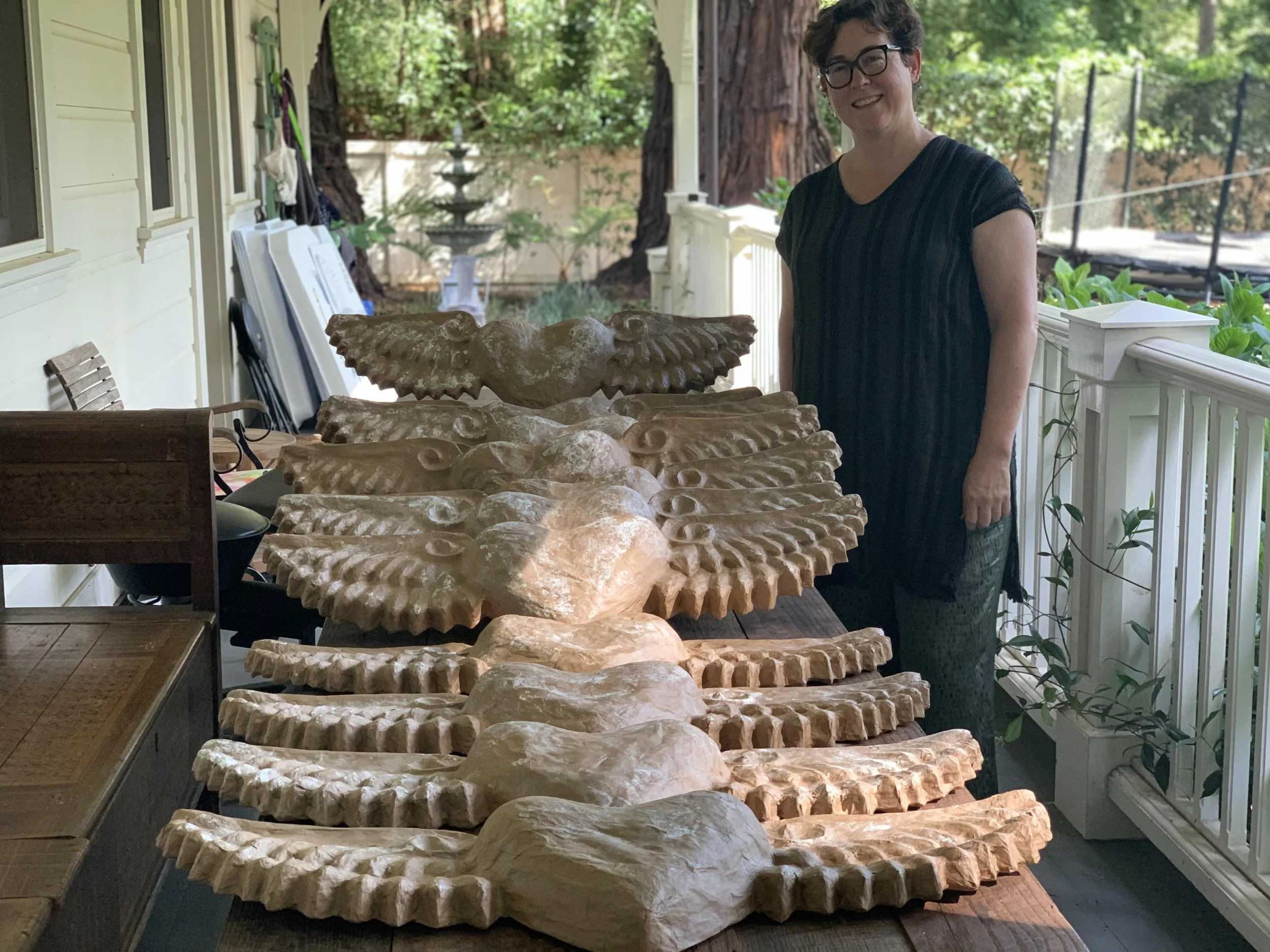 Tracy in front of a line of winged hearts