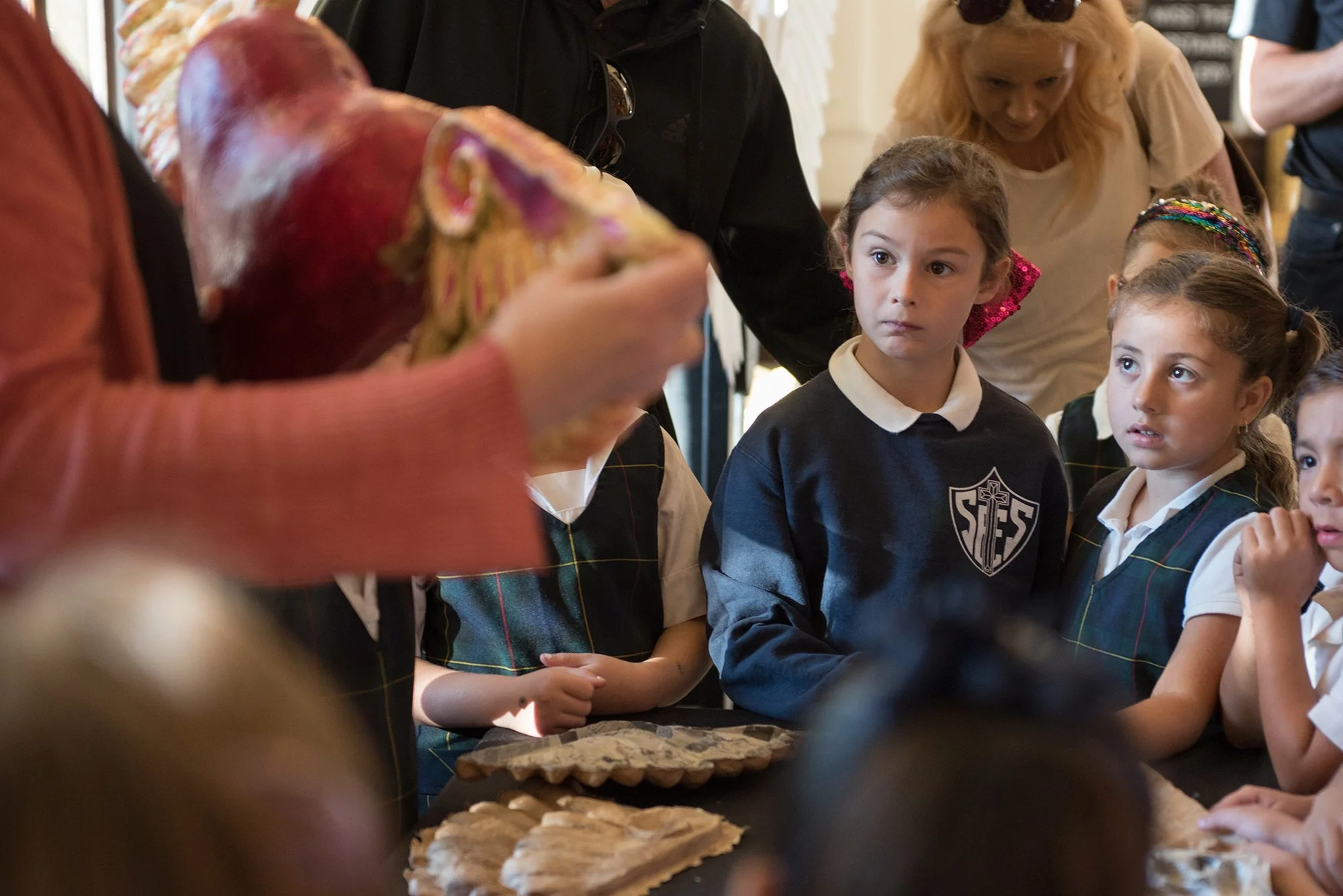 Children listening to a presentation about the art